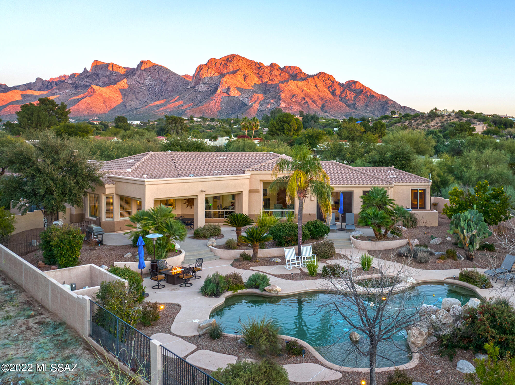 A very gorgeous home in a great location in Oro Valley.Very close to everything you need while maintaining a feeling of privacy due to this home being on 1.07 acres.Parking will never be an issue, as the driveway is big enough for many cars in addition to the 2 car garage. Upgraded features include but are not limited to: Pebble tech pool with spa and fountain, water conditioner system,high ceilings, LOTS of natural light, chef's kitchen, irrigation system in front and backyard,custom landscape lighting package, new sewer connection, fresh exterior&interior paint and more! Inside is spacious,tastefully updated and very well maintained.Step out into your back yard and experience your own personal paradise!This home will meet and exceed your expectations for luxury living.Will not last long!