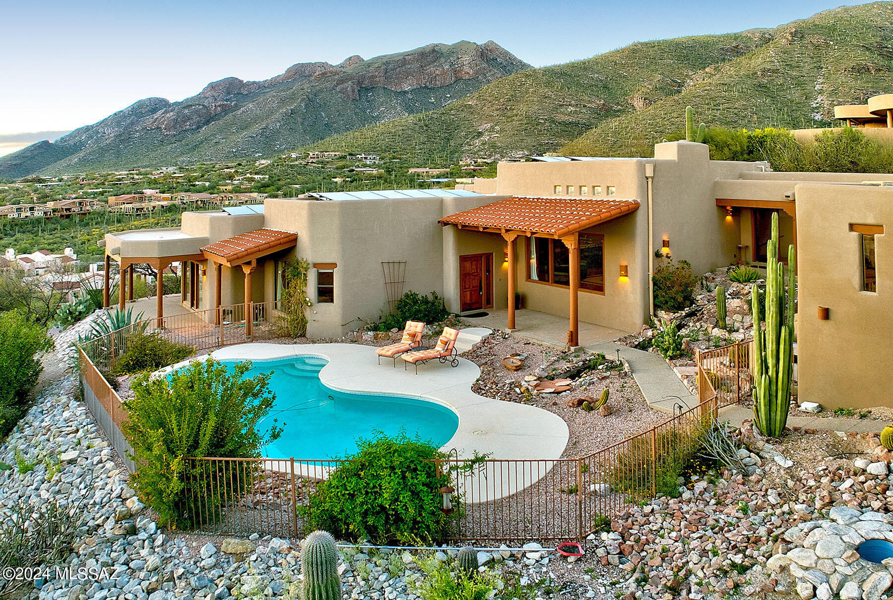 Welcome to your (fully owned) solar dream home nestled in the prestigious Tucson foothills, where beauty & luxury are paramount. A 24/7 manned gate is prelude to the splendor of the Sin Vacas community. This stunning residence boasts separate living & family rooms, each offering unique features. Picture yourself enjoying the natural light of the family room while soaking in the breathtaking city views or unwinding by the living room wet bar. The primary suite boasts a walk-in shower, cozy fireplace, private access to a covered patio, jacuzzi tub & spacious walk-in closet. The well-appointed kitchen, equipped with ample cabinets, granite counters & island, with  a breakfast bar, perfect for casual dining or hosting gatherings. OWNED SOLAR runs the house!! See MORE tab Harness our abundant sunshine with owned solar panels ensuring lower electric bills. Step outside to your own oasis, where a sparkling heated pool awaits, offering the ideal spot for refreshing swims & relaxation. With a 3-car garage featuring extra workshop space, you'll have plenty of room for hobbies & storage. Conveniently located just minutes away from Foothills & downtown shopping, this exceptional home offers the epitome of luxury living in one of Tucson's most sought-after neighborhoods. Don't miss the opportunity to make this your forever home and experience the ultimate blend of elegance, comfort, and convenience.