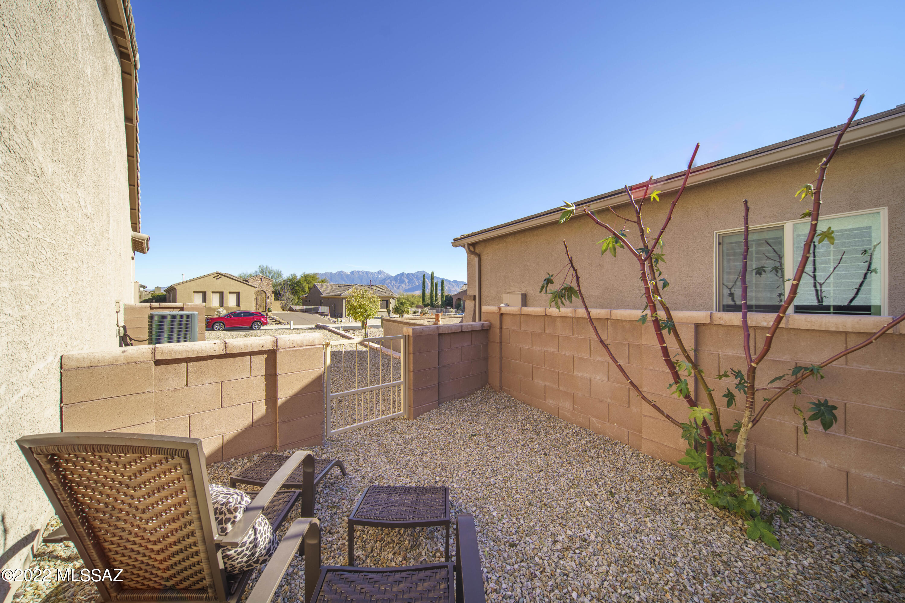 This beauty was built in 2019 and it has barely been used during its short life!  All of the furniture & furnishings convey with the house.  From the moment you step through the front door, you'll be charmed by all the natural light and it's outstanding layout.  It is built the way you want to live and entertain. There are tile floors throughout and a gorgeous great room that brings together the main living area, dining area and a well designed kitchen.  In back you will find a great start to the backyard with a covered patio, decorative gravel, trees & shrubs.  On the South side of the house is a wonderful spot from which to watch the ever-changing Santa Ritas.  Don't wait as this one won't last long!