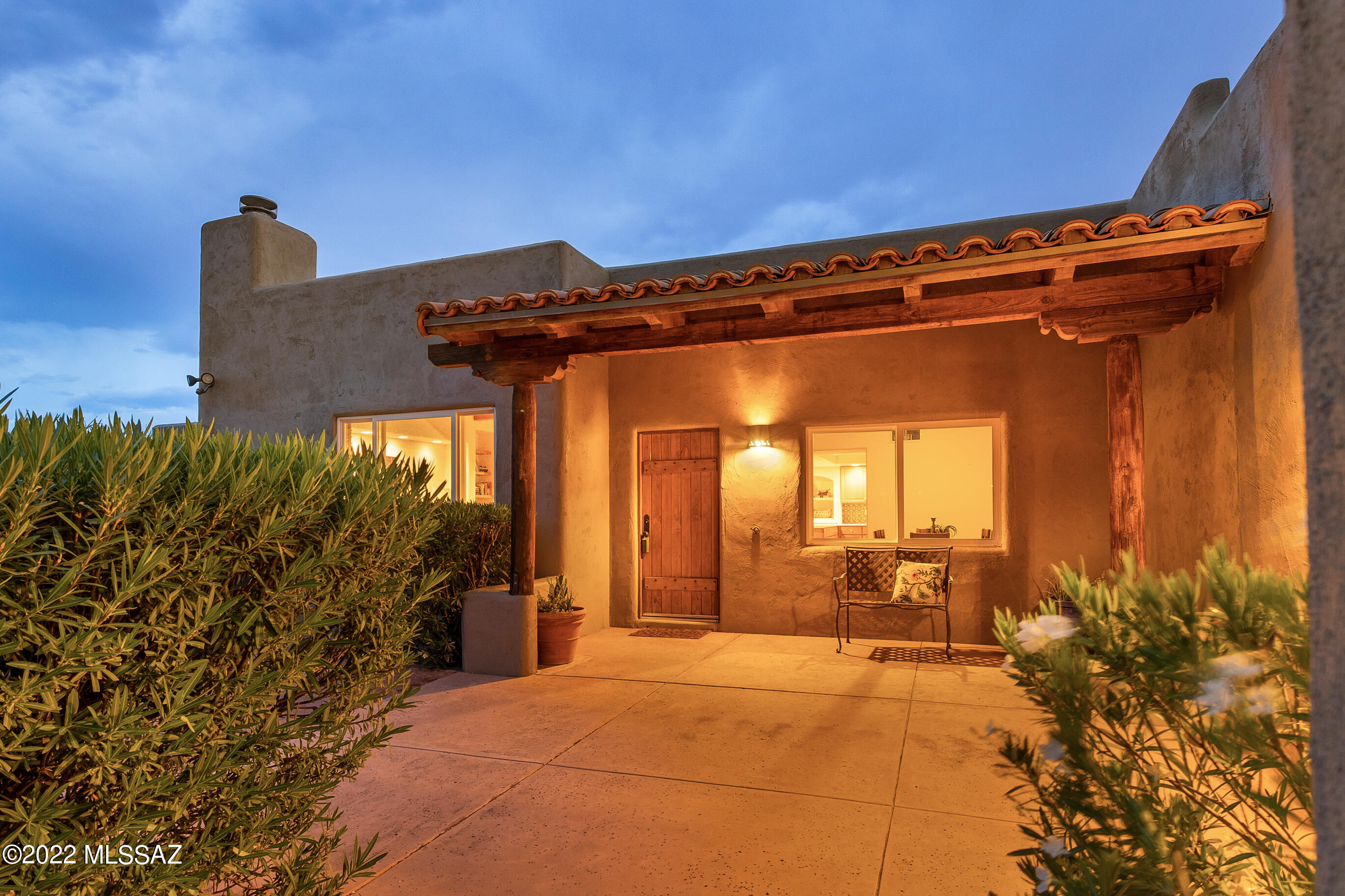 Perched atop a more than three acre parcel in the Catalina Foothills, this Santa Fe style residence offers panoramic views of Tucson's many stunning mountain ranges. This home was custom built to capture the best of its private, serene setting while embodying all the local charm of our Sonoran desert. Hand painted walls, rough sawn beams, solid wood doors, and Saltillo tile all add to the classic feel. The primary suite has a large walk-in closet, dressing area, en suite bathroom with soaking tub and separate shower. All bathrooms and the kitchen backsplash are tiled with a Spanish influence in mind. A split Floorplan also could easy accommodate long term guests or multi generational living as it has a second suite with kiva style fireplace and door to the expansive wrap around patio. Enjoy 360 degree views from the many outdoor spaces or The Loop which is just immediately south of this incredible property.