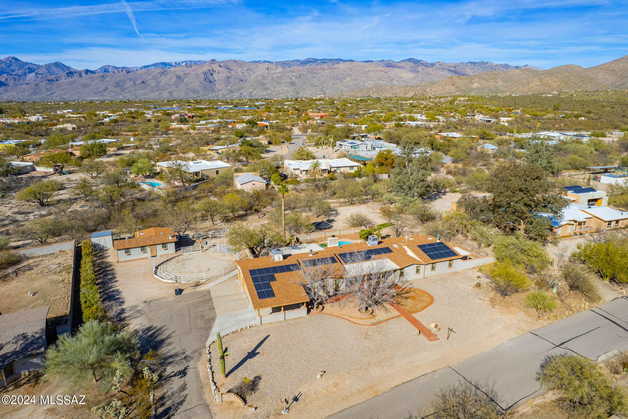 Solar will be PAID OFF at close of escrow! With Catalina & Rincon mountain views, this ranch style home located in ''A'' rated Tanque Verde School District, offers great living area spaces along with a pool and outdoor fireplace for your entertaining wants! To top it off, on the property there is solar, a nice guest house, oversized garage, attached carport, shed, also a horse corral and arena. Inside this well-maintained home you will find scored concrete floors, a good sized eat-in kitchen with newer stainless appliances, kitchen island, 3 fireplaces, living room, 2 bonus rooms, large master with fireplace, barn door to bath and slider to the backyard. The guest house is a 1 bedroom, 1 bath, for your guests comfort. See documents for additional info. Come view and be ready to move in!