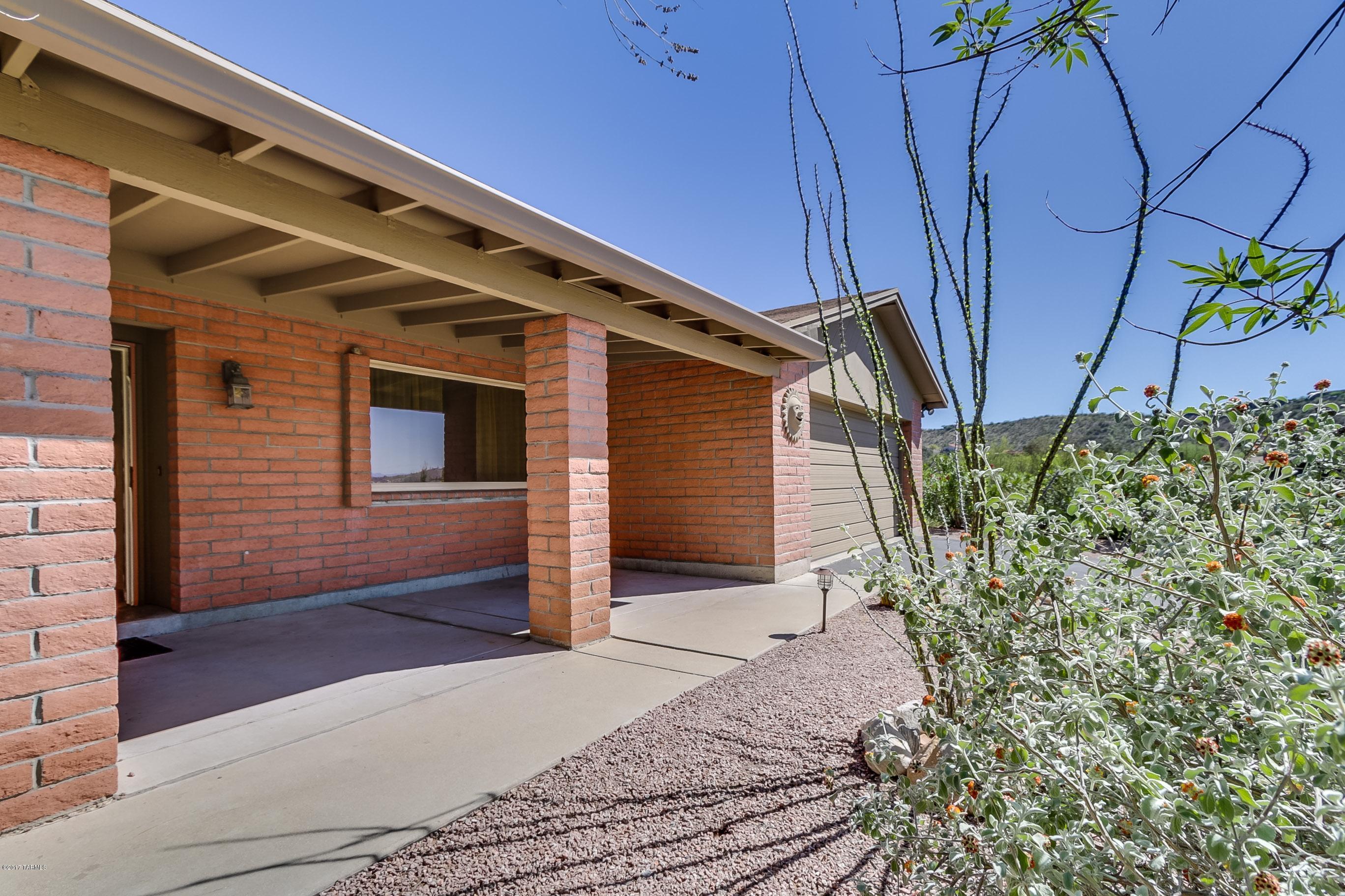 Enjoy your desert southwest lifestyle in this beautiful home.  Conveniently located near shopping, outdoor activities, and award-winning schools, this home offers newer vinyl dual pane windows, Lennox gas furnace, water heater, and updated kitchen and baths with granite slab countertops.  Front and rear covered porches for easy outdoor living.  Large storage room and cabinetry in garage.  Very clean and in great condition, you are sure to love this home.  Seller is offering a home warranty at closing, call today!