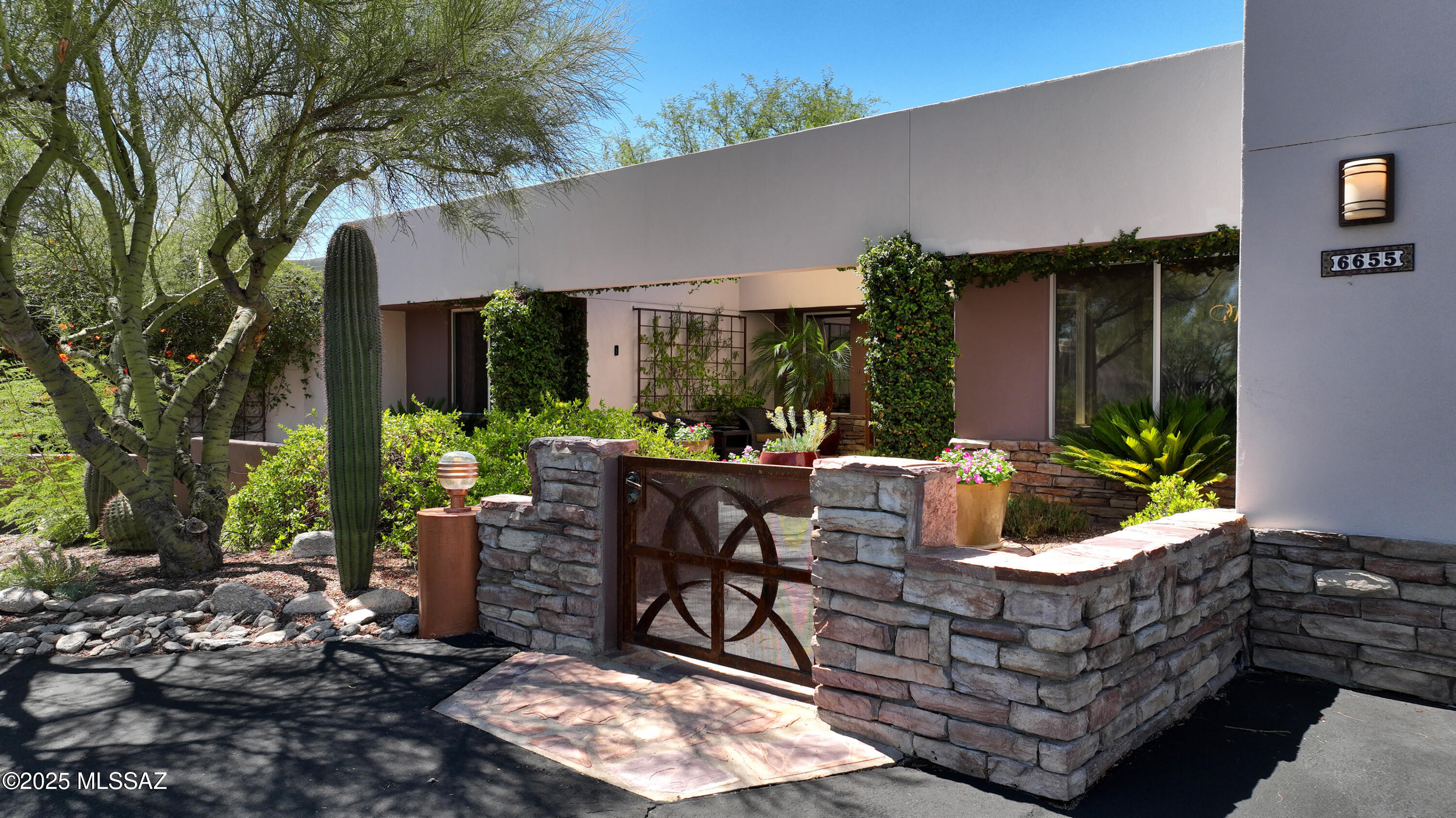 Enjoy unobstructed Catalina Mountain views from this exceptional 4BR, 3BA, custom contemporary home on a premium cul-de-sac in desirable Cimarron Foothills Estates. Beautifully updated and meticulously maintained, this foothills residence features high ceilings, beautiful wide open windows showcasing unobstructed mountain views as you enter.Stunning copper metallic coated floors throughtout.   The renovated kitchen is a chef's dream, featuring a center island, plus breakfast bar, custom walnut cabinetry, Blue Star double ovens and a Thermador 6 burner gas cooktop, open to the family room with two way fireplace.,  Step outside to a spacious covered patio, grassy area and adjacent deck both creating a true outdoor living/dining room with the majestic mountain views and sparkling pool as a backdrop.  The primary suite offers everything, spacious walk in closet, double vanity and floating cabinetry. Bonus flex area off of the primary bedroom area, to use as study, exercise, sitting area. Wonderful 3 spacious guest bedrooms and guest bath complete the sleeping areas. This home features seller owned solar, total of 5 car garages, which 3 car is separate with 60 amp electric. Excellent location in the foothills, close to world class golf, shopping, restaurants and schools This is the first time this beauty has ever been on market.  One seller is a licensed real estate broker in the state of Arizona