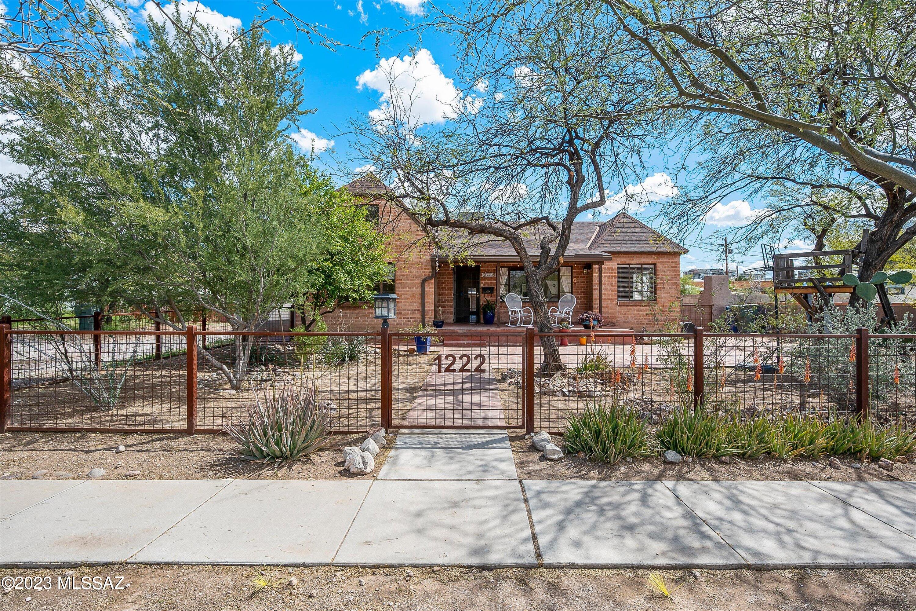 Stunning historic TUDOR REVIVAL home within a mile of the University of Arizona in highly desirable Feldman's Historic District. Sam Hughes quality and charm for so much less. Your own oasis in the center of everything. Close to restaurants, theaters and activities around the UofA campus & downtown. Easy living on the fully contained main level. Beautiful finished basement w/plenty of room for entertainment, home theater or whatever your imagination takes you. Plenty of room for your vehicles and toys in the 2 car garage, plus additional parking space on property. Owned solar panels, rain water harvesting and much, much more! One of a kind, must see to appreciate. Don't miss the ''Home Special Features'' under the attached documents. RANGE PRICE $850,000-$900,000. A true Tucson Gem!