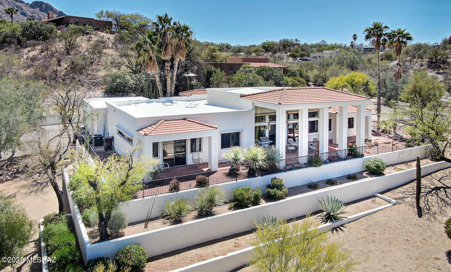 Experience luxury living in this beautifully designed home with breathtaking views of Oro Valley Country Club's captivating 18th lake hole.  Boasting an impressive 3 spacious bedrooms, 4 full baths, Den/Office and a separate CASITA, this home is nestled on an elevated prime corner lot in the prestigious Oro Valley Heights with the convenience of NO HOA. With 3580 sqft of grandeur, the main house showcases sleek tile flooring throughout and a voluminous living and dining areas, enhanced by towering 14 ft ceilings, that provide the perfect backdrop for hosting grand dinner parties or intimate gatherings. Large windows fill the space with radiant natural light and ensure you are constantly immersed in the serenity of the golf course views.  Large kitchen, amply fitted with cabinetry and expansive counter space. The master suite is a tranquil retreat, complete with direct access to the back porch where you can unwind and soak in the views. The ensuite bathroom features double sinks and a walk-in shower. With a desirable split floor plan this home also features two additional bedrooms, each accompanied by an ensuite bathroom with walk-in shower and spacious closets. A large office/den, another full bath and installed rolling shutters in most windows add to the home's extra features. The 829 sqft detached Casita with new HVAC introduces an array of multifunctional opportunities. Perfectly suited for accommodating friends and family, transforming into an art studio, establishing as a standalone office, or serving as a dedicated hobby space. The 3-car garage and long driveway offers abundant parking space. The convenience doesn't end here, though; a large laundry room, fitted with plentiful storage cabinetry, ensures that your home remains organized and clutter-free. All furniture included in the sale with a small list of exceptions. Overall, this fantastic home is ideally situated close to shopping areas and restaurants. A remarkable blend of luxury and comfort, this home truly promises an exceptional lifestyle!