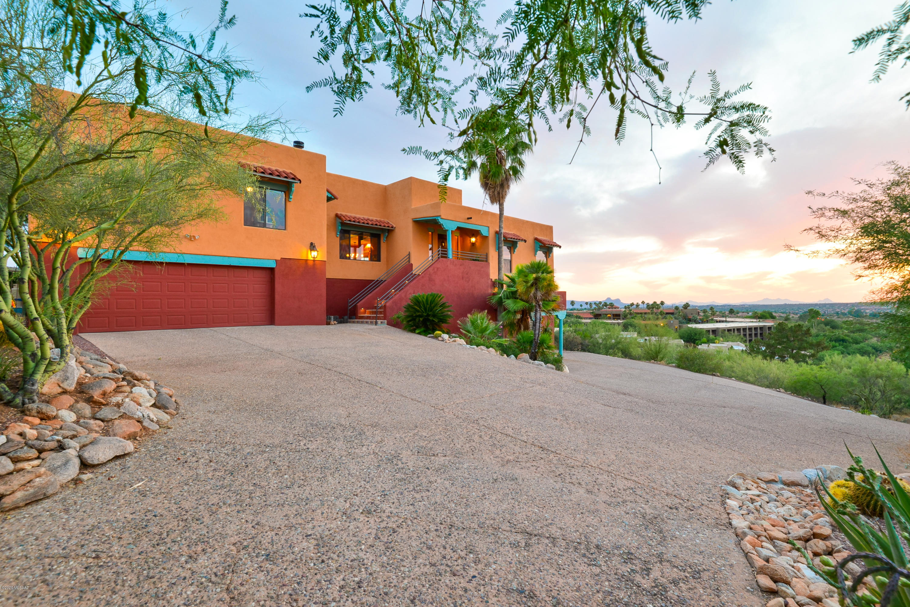 Stunning panoramic views of Pusch Ridge in this resort like setting located on the 8th tee of the El conquistador Resort!.87 acres,4006 sqft 4 Br in main house.905 sqft separate entrance 1 Br guest house w/full kitchen,LR,DR, & laundry.Dramatic great room boasts huge picture window w/wood beam ceilings,custom FP.Chef's kitchen.GE monogram frig,Jennair induction cooktop.Walk in pantry.Custom saguaro ribbed cabinets.Granite cc'tops w/breakfast bar.NEW ELVEVATOR!Just tiled spacious master suite w/private balcony.See thru FP to private en suite w/Bain Ulra Jetair tub.Fabulous city,mountain,sunset views from this extended covered balcony w/shades & misting system.Hollywood movie theater w/7 reclining chairs.Game room/gym room & kitchenette.AMAZING professionally landscaped private lush backyard oasis. Citrus trees, palm trees and more! Pebble tec pool & waterfall. Views are incredible! Double tandem 4 car garage. RV PARKING. No HOA! Dog Run. A must see property!
