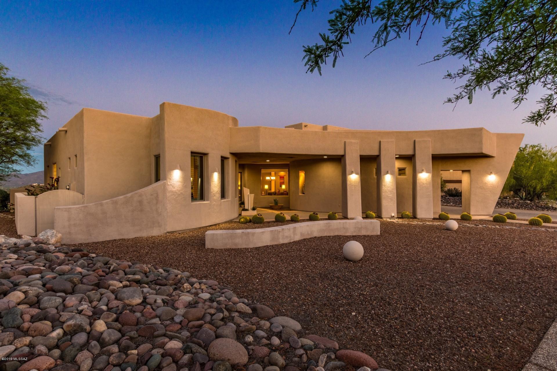 Stunning Mark Soloway design - an award winning, Arizona architecture and interior design firm, serving clients all over the world and creating a fusion of architecture and nature, resulting in a custom home that is at-one with the environment. This property truly captures the desert in all its glory and breathtaking mountain and city light views from the indoor and outdoor living spaces, including upstairs view room. The interior of the home offers comfortable living and a perfect atmosphere for family and entertaining. The grand living room makes a statement with soaring ceilings, wall of windows, and 3-way fireplace. Gourmet kitchen features granite countertops, a spacious island, flat cooktop, and double-wall ovens. The master suite is a true retreat, boasting sitting room with exquisite views, private exit, walk-in closet with built-ins, and luxurious spa-like bath with jetted tub. Artistic architectural elements such as coffered ceilings, beautiful arches, and art niches with lighting are found throughout. Expansive Flagstone patio extends across the back of the home, providing many entertainment areas, built-in BBQ and putting green.  Extending 650' beyond the wall is environmentally protected land â€“ views will never be obstructed!