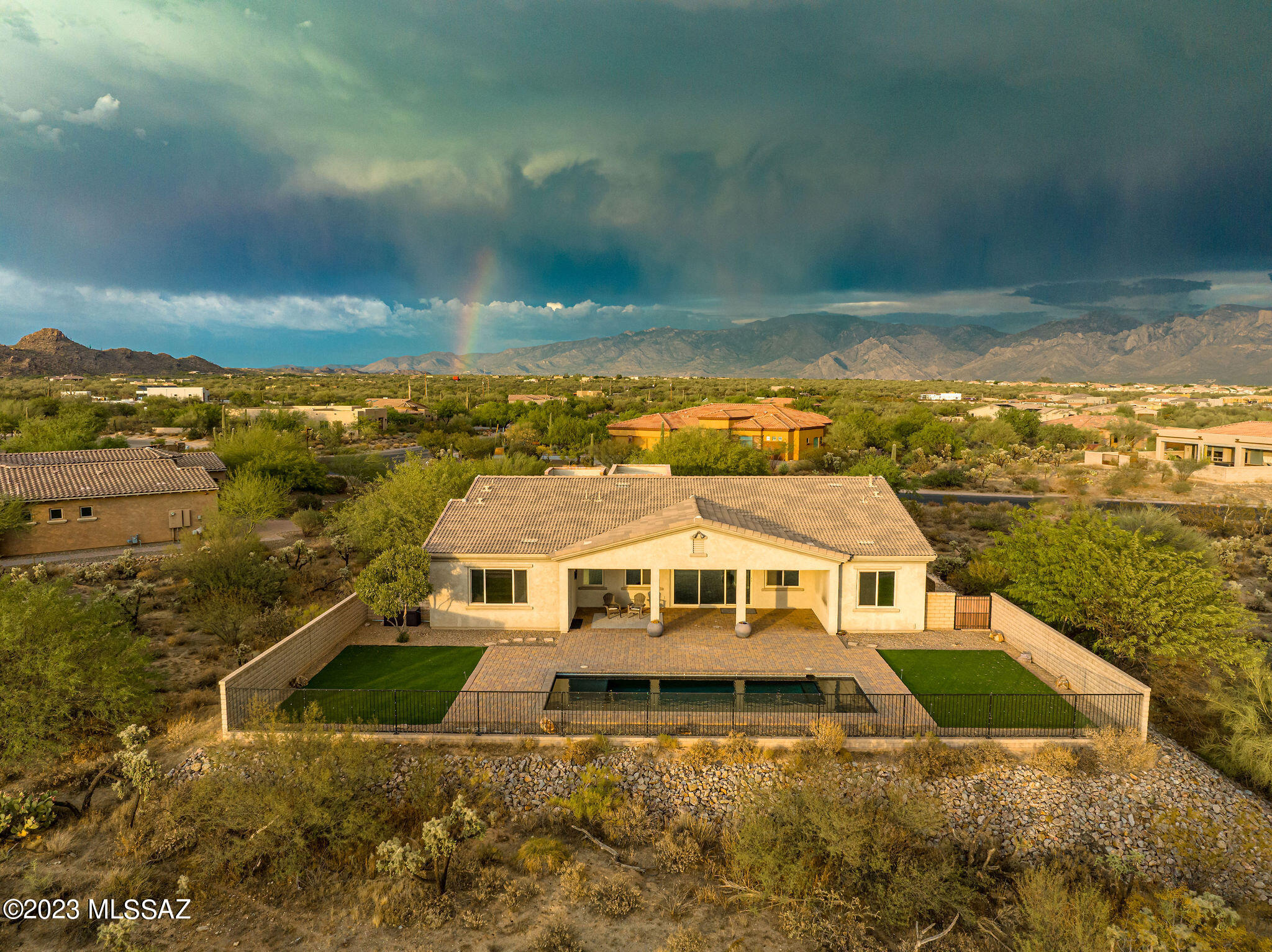 This modern home has an Incredible premium lot with mountain views and privacy. This lot is just under an acre and has common area behind the home. The Gourmet kitchen has custom cabinetry, upgraded hardware, crown molding. A huge Island with seating for 4, pendant lights, granite countertops, undermount sink, Stainless steel appliances to include:  double oven, gas cooktop, built in microwave, and a stainless steel hood.  A butlers pantry with extra cabinetry and granite countertops. The guest casita has everything you need.  A beautiful kitchen with a cooktop, built in microwave, refrigerator, undermount sink, new cabinetry, backsplash, bathroom with a walk in shower w/tile surround to the ceiling, Separate heating/cooling. This room would make a great theatre, gym or play room. Enjoy the beautiful pool with a lagoon and a removable safety fence. Brick paver extended patio, TV hook up, ceiling fan, artificial grass for an easy care backyard. The master suite is very spacious with a door to the patio, ceiling fan, sitting area, dual vanities, granite countertops, undermount sinks, upgraded lighting and faucets, framed mirrors, garden tub, walk in shower with tile surround to the ceiling and a large walk in closet. The office/den has a built in desk and drawer unit. The laundry room is very large with lower and upper cabinets for storage and a granite countertop. 3 car garage. Close to Shopping, I-10, Restaurants, mall, Ritz Carlton resort, golf, Dove Mountain and great hiking trails.