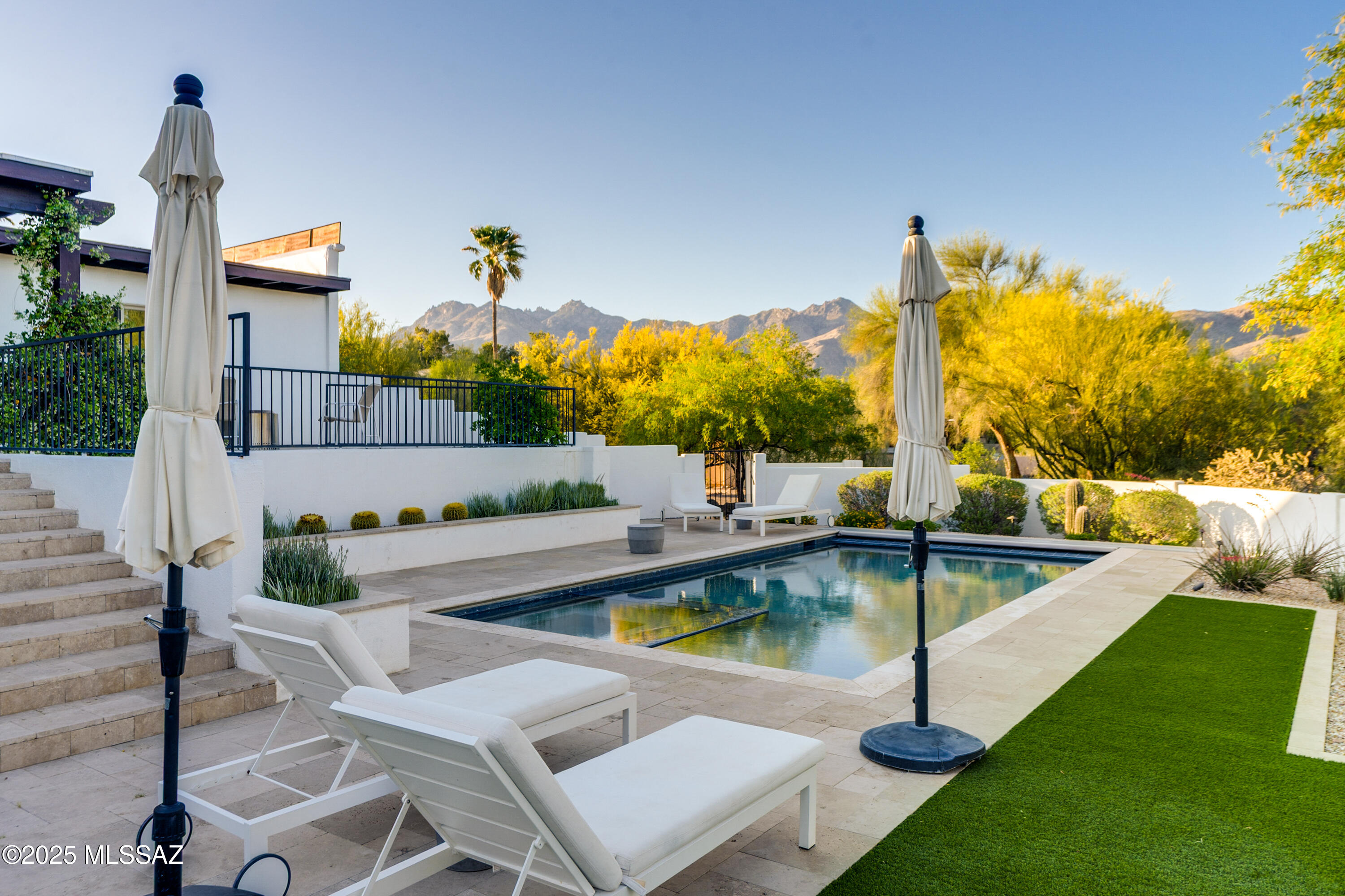 Welcome to this beautifully updated gem nestled in the desirable NE Foothills of Tucson. Situated on 1/2 acre, this home offers the perfect blend of modern upgrades and tranquil outdoor living. Open kitchen with quartz countertops. Great floorplan with 3 ensuite bedrooms. The living spaces are bright and inviting with abundant natural light. The stunning backyard was transformed in 2019 with the addition of a heated pool and spa. Surrounded by lush landscaping and serene mountain views. Located in a peaceful neighborhood yet conveniently close to shopping, dining and outdoor recreation.