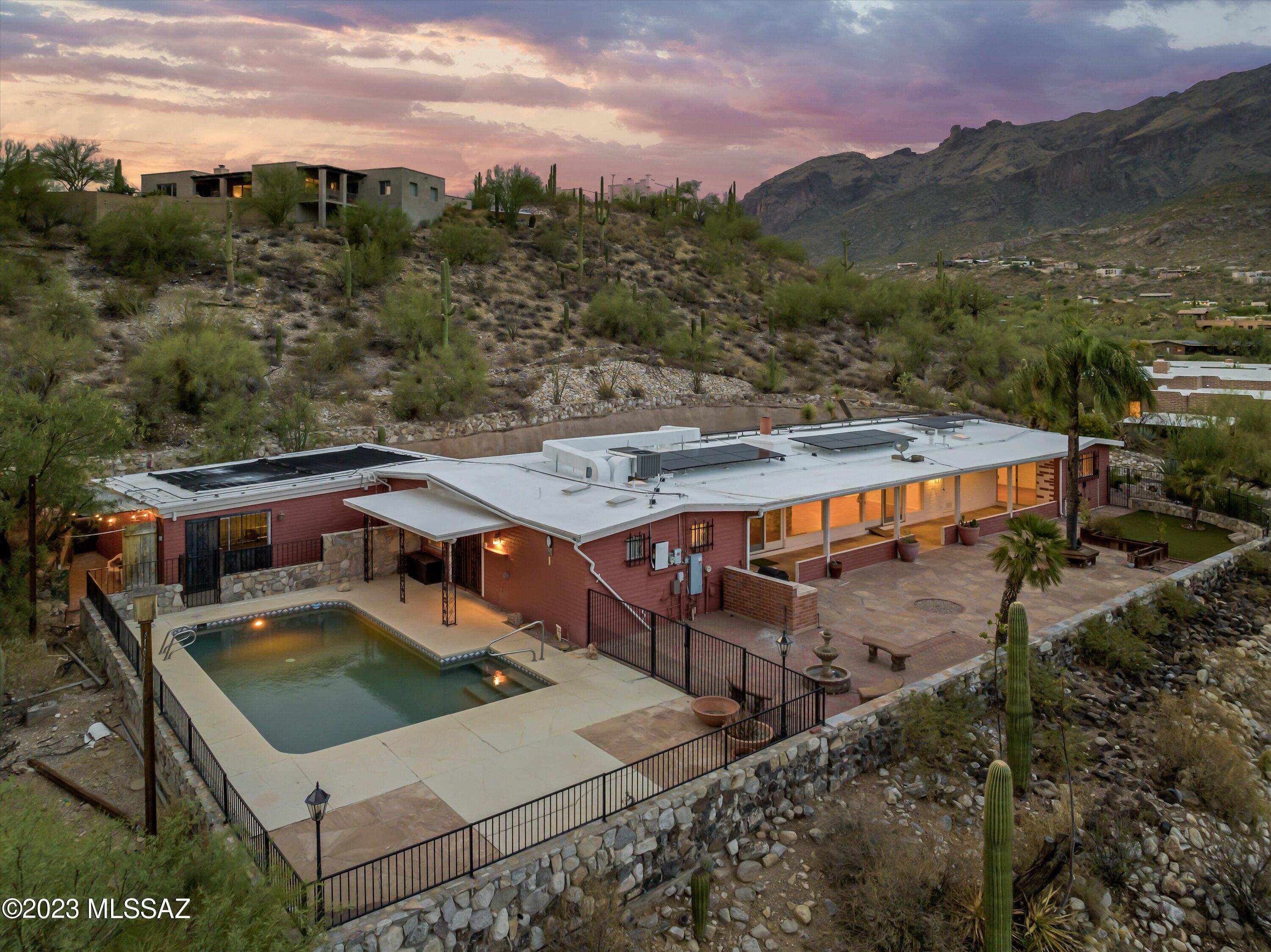 Premium lot with Pool and unobstructed views of Catalina, Rincon, and city lights in Catalina Foothills. 2 Primaries en-suites with updated vanities; 2 extra guest rooms; hallway bathroom; double sided fireplace to add warmth, charm, and ambiance to two living areas; and a cozy breakfast nook that brings everyone together.  Wonderful Smart home- managed by a phone app; Updated HVACs; Solar panels- Fully paid off with an accepted offer; Amazing location in Catalina Foothills School District, only minutes drive to La Encantada Outdoor shopping mall, the Western La Paloma Resort, and many more.