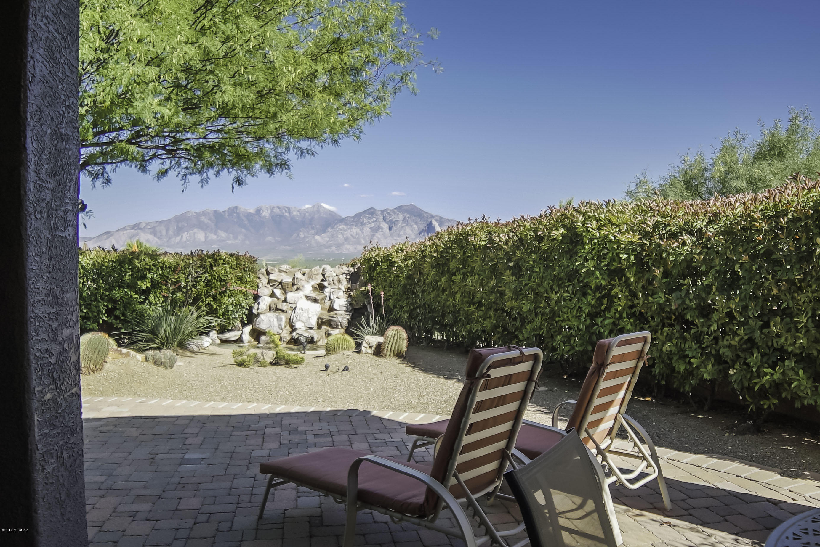 If views are important, this house belongs on your very short list.  You'll be so lost in the magnificent view of the Santa Ritas that you may miss everything this gorgeous home has to offer.  Wide open floor is built the way YOU want to live and it makes entertaining a joy!  There are tile floors on the diagonal in the main living areas, ceiling fans where you want them, new quartz counters in the kitchen, beautiful upgraded cabinets, and so much more.  Step into the back yard and you'll be impressed by not only the views but the privacy that surrounds you.  The sound of water and birds serenade you as you revel in the tranquility that engulfs you.  Don't wait...this beauty won't last.