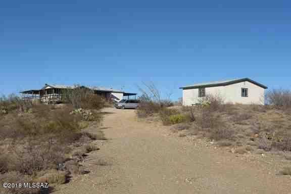 Priced below recent appraisal! 5 acres with hundreds of acres of State Trust Land bordering the north edge of property. Large deck with unobstructed views. 1200sf manufactured home with large wood deck on all sides. Detached 2-car garage. Estate sale, sold as-is.