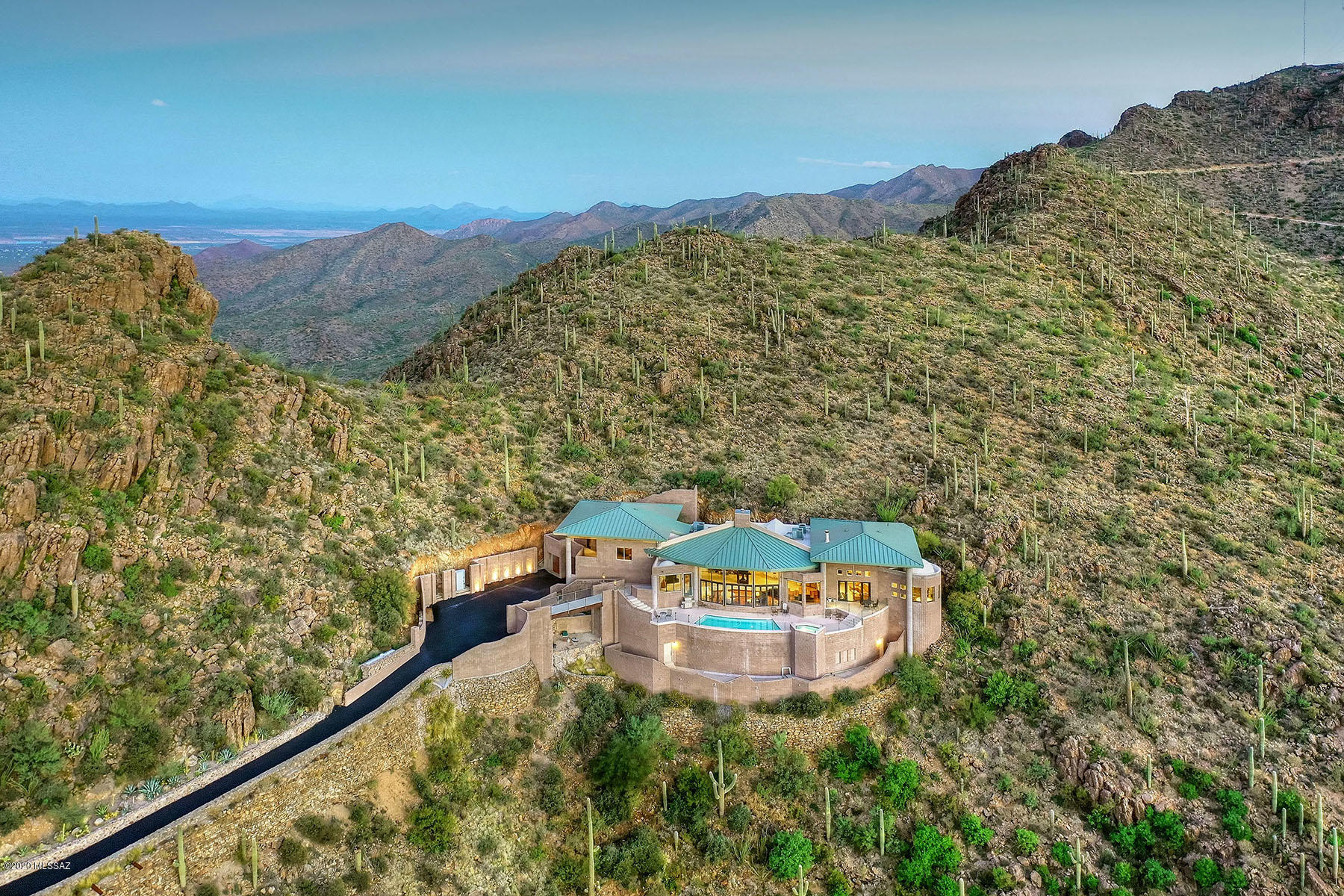 Seller will consider offers between $1,950,000 and $2,250,000.''The highest home in Tucson'', with world-class views from this spectacular contemporary perched high atop the Tucson Mountains — 1,500 feet above the city floor.  The home offers a total of 9,284 sq. ft. including the 5,625 finished main level and 3,659 partially finished lower level (rooms could be used for  wine cellar, workshop, game room, theater, gym/exercise room, shooting range). This remarkable property is situated within two gated communities on 7.72 acres including tax parcels 212-06-075A and 212-06-079B.  From mountain range to mountain range, walls of windows capture the entirety of the Tucson valley, sunrises, sunsets, city lights and yet close to downtown and the University of Arizona. Carved out of the mountain, featured are 25' ceilings, 40' columns, four roof structures,glorious great room opening to the chef's kitchen, gracious master suite with sitting room, soaring domed master bath ceiling and loft/library.  Built in 2009, with remodeling completed over the past four years, this showplace with pool and spa is surrounded by Tucson Mountain Park and Saguaro National Park.  Sit back in a sanctuary of silence and creation