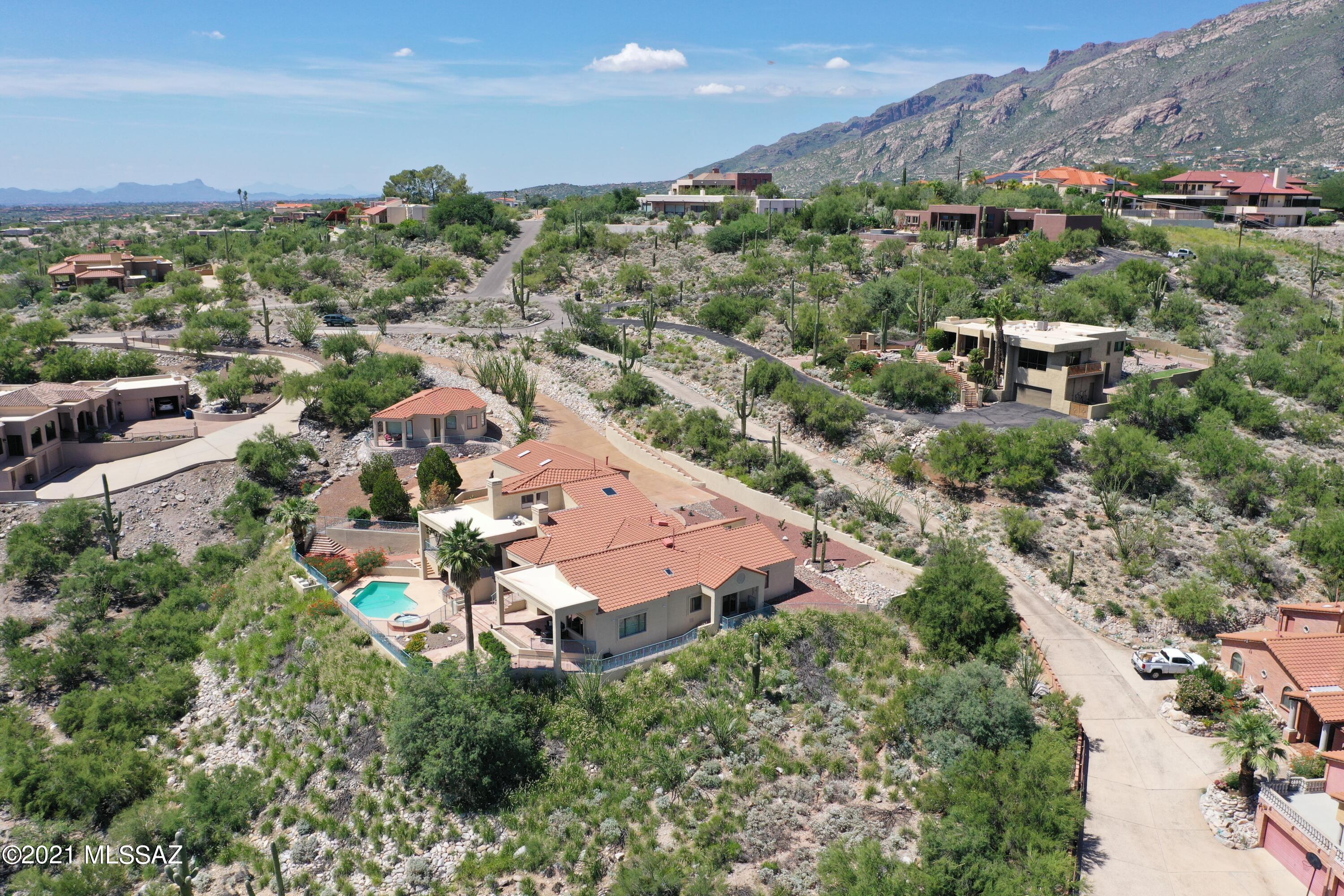 Gorgeous Custom Mediterranean home with guest house sitting high up in the Foothills. This exceptional property has panoramic views from almost all living areas, patios & the guest house. 5 bdrms/4 bath main hm - travertine floors, gourmet kitchen Dacor & Wolf SS appliances, granite countertops, and breakfast bar, perfect for entertaining with two living areas. The main bedroom has large windows and doors to the incredible views & patios and is also equipped with a full home theatre system. The guest bedrooms, all with their own special views, also have large bay windows and walk in closets. This is also a fully automated smart house with 2.18 acres of privacy. Built in BBQ, fridge, bathroom, w/shower and sauna located by the pool. Large guest house w/views and almost 1,000 sf. of space.