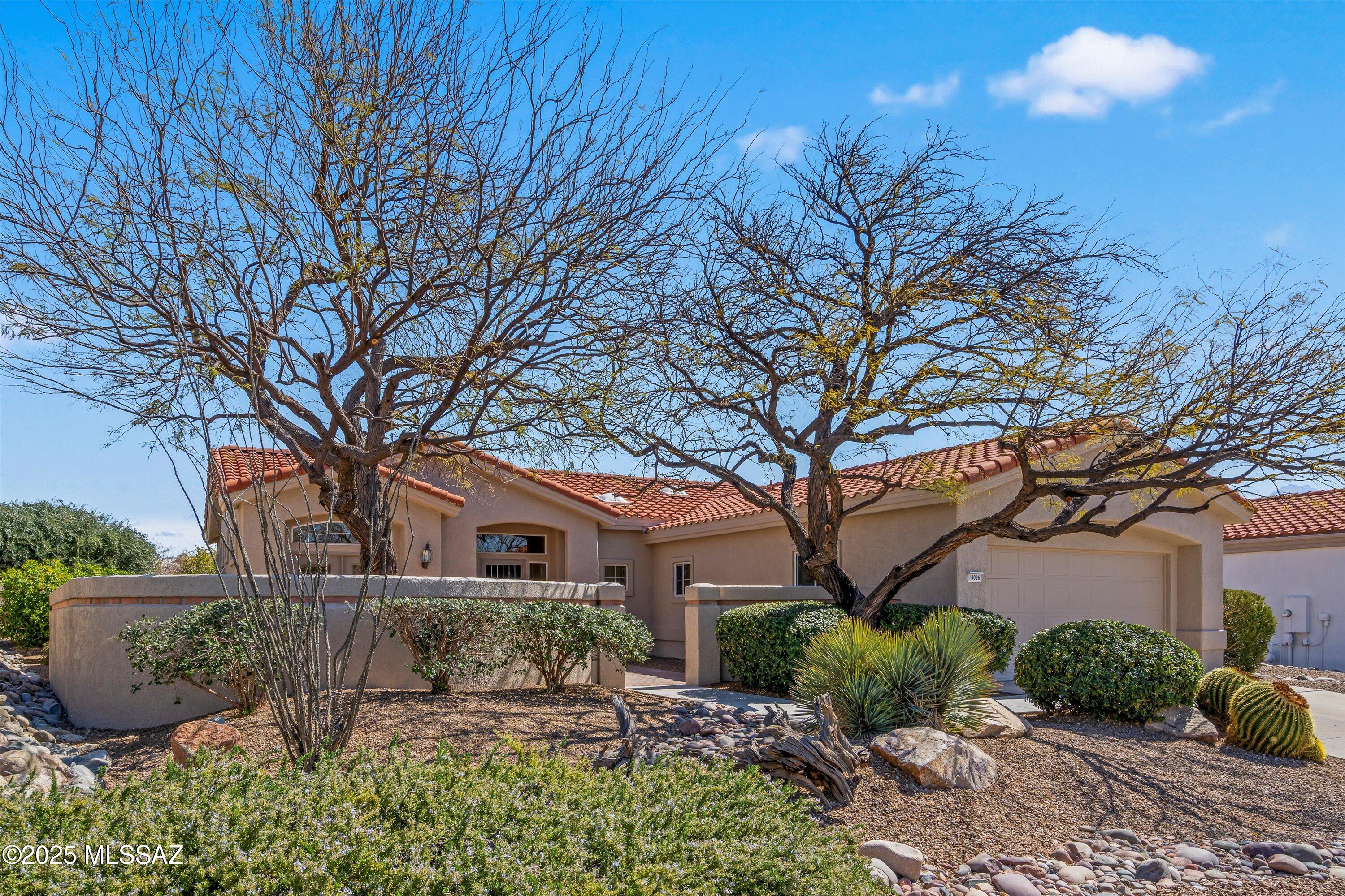 Gorgeous 2BD/2BA +Den (1,635 sq ft) home boasts a large front courtyard, tranquil rear oasis, plus striking Catalina views from inside & out. New roof plus interior/exterior paint including all cabinetry. Enter to find a flowing floor plan with high ceilings, walls of windows, living room with fireplace and views plus spacious dining area off kitchen with views. Chef's kitchen hosts stainless appliances, pull-out pantry shelves and light filtering skylight. Spacious Owner's suite with views hosts dual sink vanity plus walk-in shower & closet. Guest room, Den off courtyard, hall bath, laundry plus extended garage. Enjoy brick paver patios front & rear plus rear covered patio, trickling fountain, pristine landscape with lush green lawn and spectacular views! Sun City Active Adult Community.
