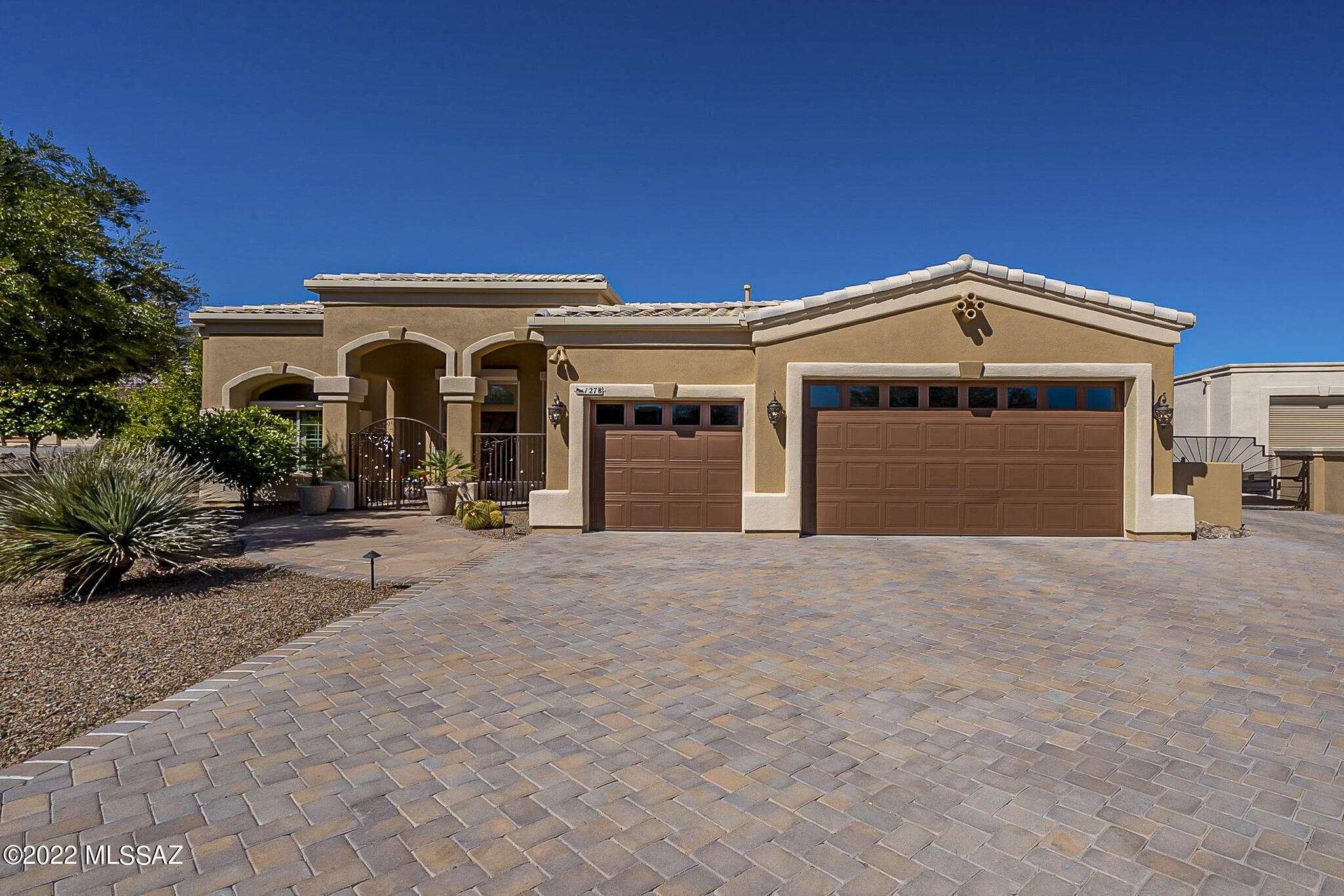 RESORT LIVING AT HOME!!  Exceptional home w/triple & RV gar.  Vaulted ceilings.  Split floorplan.  20'' ceramic tile throughout except carpeted bedrooms & den.  Rear patio refuge w/solar & gas heated conv pool & spa, outdoor kitchen, gazebo, covered porch, cool decking, flagstone, artificial turf, shrubs, mature landscaping  & deco gravel.  Plantation & outdoor rolling shutters throughout.  Gourmet kitchen features maple cabinets w/self closing drawers, granite counters, gas cooktop, bank of drawers, warming drawer, breakfast bar & nook, split-faced travertine back splash & gracious formal dining room.    Permanent 10kw Generac gas.  Laundry room w/full-sized stack washer & dryer.   Man cave RV garage to end all!