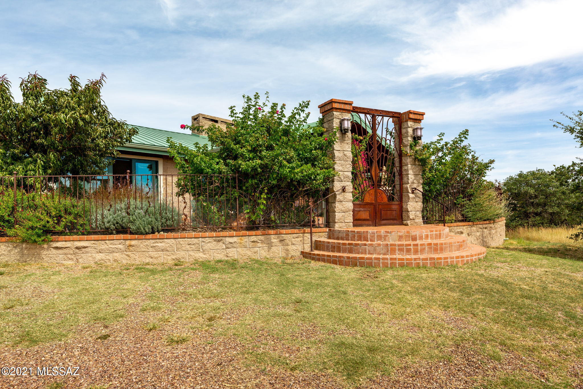 In the heart of Arizona, wine country awaits a mystical place: 1 Sherwood Forest Lane. 
This extraordinary 20 acres estate in the rolling Canelo Hills nestled among the Oaks, 
Junipers and Manzanita and surrounded by the Catalinas, Rincons, Santa Ritas, Huachucas, 
Whetstones and Mustang mountain ranges offer panoramic views. A secluded sanctuary
of peace and tranquility. This Labor of love by builder/architect Frank Wicks surrounded by National Forest and the Babacomari land grant offering extraordinary privacy. Enter through iron gates to a fenced courtyard that includes 
a fish pond filled with aquatic plants and a fountain. The impressive grapevine motif metal and glass door that hint at the quality and craftmanships throughout the home.