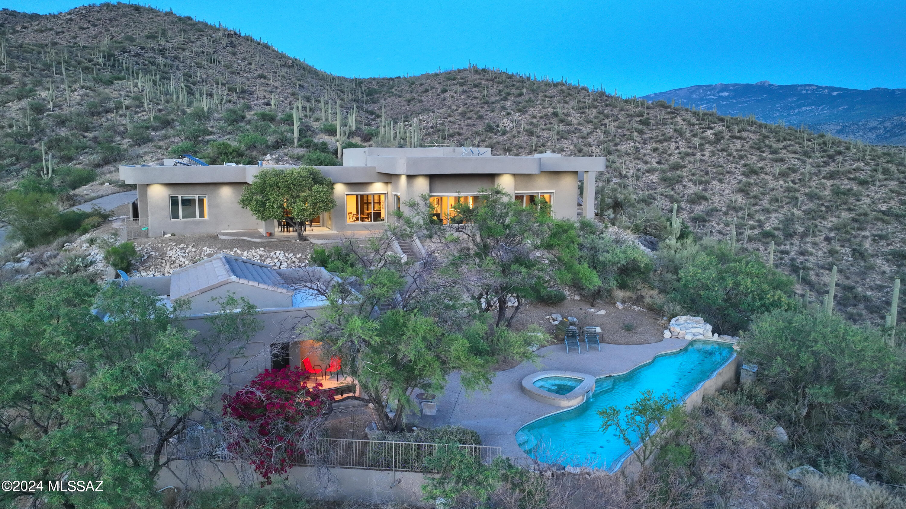 VIEWS, VIEWS & MORE VIEWS! This is your opportunity to own this incredible estate at the top of the gated Redington Ranch neighborhood. Located on over 7 incredibly private acres, surrounded by untouched National Forest land. The 6,151 sq ft main home is lined with travertine tile, new carpet, fresh interior and exterior paint. Step into the gourmet kitchen with granite counters and floor to ceiling cabinets. Enjoy the fireplace, wood ceilings and panoramic city views from the family room or relax in one of the 3 large on suite bedrooms. The oversized 3 car garage with workshop is an added bonus. Head out back to see the beautiful negative edge pool and spa! The 763 sq ft guest house is a fantastic addition for family, guests, or just entertaining by the pool. NO HOA. Take a tour today!