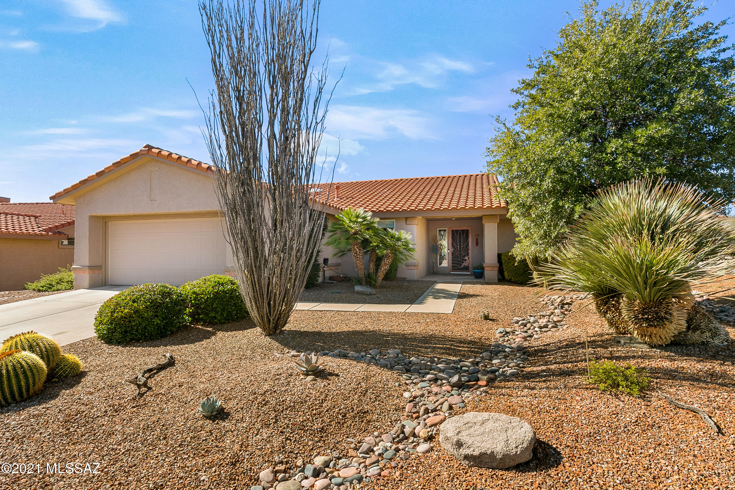 Welcome to your new 2 bedroom 2 bathroom home in the Sun City Vistoso 55+ community in the beautiful city of Oro Valley!  This home features desert landscaping, updated exterior paint, and gorgeous mountain views! Inside you are welcomed with a spacious floor plan, neutral toned paint and tile throughout, plenty of natural lighting, and views of the mountains from every corner. Your eat-in kitchen has abundant cabinet space, quartz countertops, stainless steel appliances, built in oven, and a huge island with a tv. Your spacious master bedroom features plush carpet, walk-in closet with built in shelving and drawers, double sink vanity, walk-in shower, and a separate powder room. The additional bedroom features ceramic tile flooring, a ceiling fan and your very own extended sewing/reading room! (an additional 73 sq ft) Your two car extended garage offers built in cabinetry. Step outside to your dream backyard that features a full length covered Ramada, a built-in gas grill, desert landscaping and a huge .24 acre lot! Your new home is conveniently located near the Catalina State Park, El Conquistador golf course, grocery stores, and just minutes from the I-10 and 77 freeway! Don't miss out on calling this beautiful dream home your very own! Schedule a showing today!