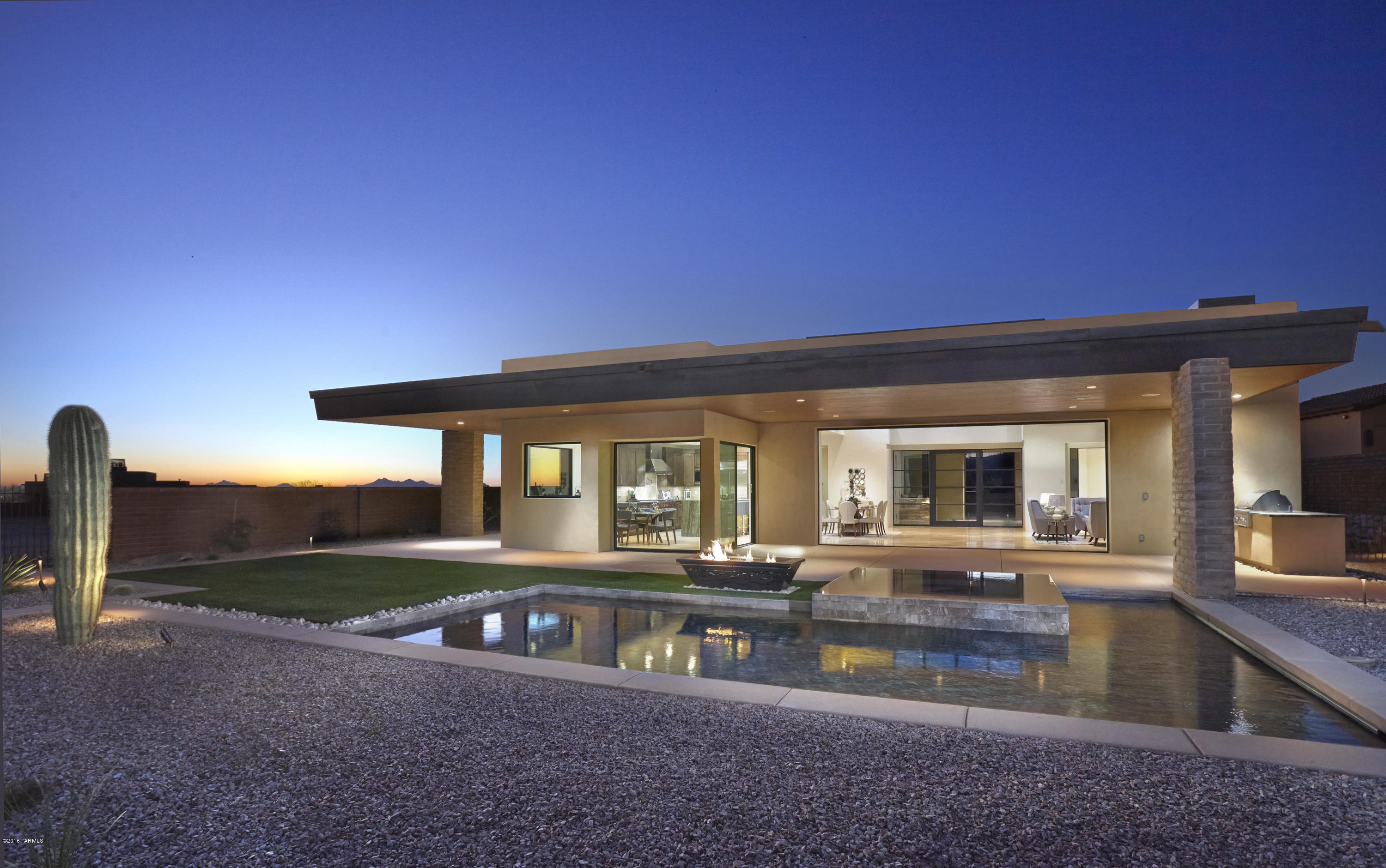 Stunning modern adobe home behind the gates of The Residences at The Ritz Carlton.  This home has views of EVERYTHING!  Sit in your living room and gaze out to the Golf Course as well as the Tortolita, Catalina and Tucson Mountain ranges.
Home features include travertine flooring, limestone bathrooms, quartzite kitchen counters, tongue and groove ceilings, huge great room with glass windows that disappear into the walls, enormous covered patio which leads out to outdoor kitchen and pebble tech pool and spa.
