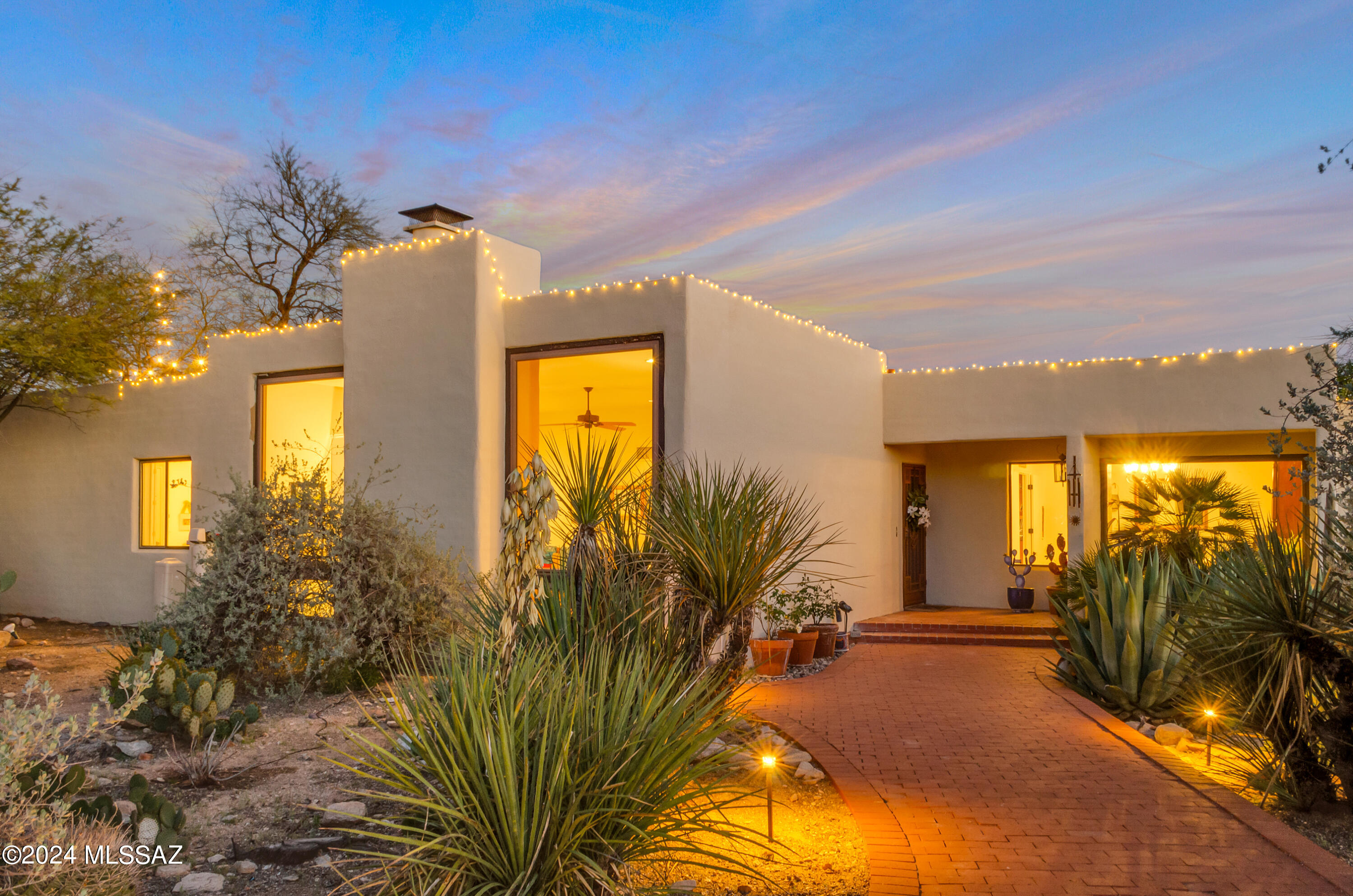 Foothills custom masonry home w/magnificent mtn views! Floor to ceiling windows frame fp in the living room facing North capturing Tucson's stunning Catalina's The grandeur continues in formal dining room complete w/picture window. Charming kitchen includes 2nd fp, granite counters, dbl oven, dishwasher, RO system & SS frig. Dine in or al fresco w/fabulous covered brick patio over looking beautiful Pebble Sheen pool. Hot tub, mature trees, flowering vegetation all create a welcome oasis. Additional patio  made for entertaining. Outdoor lighting provides resort like ambience! Owners suite offers large window for natural light, walk in closet, roomy shower, double vanity w/stone top. Neutral tile. Handsome den off kitchen. Circular paver driveway. Spectacular property on an acre.