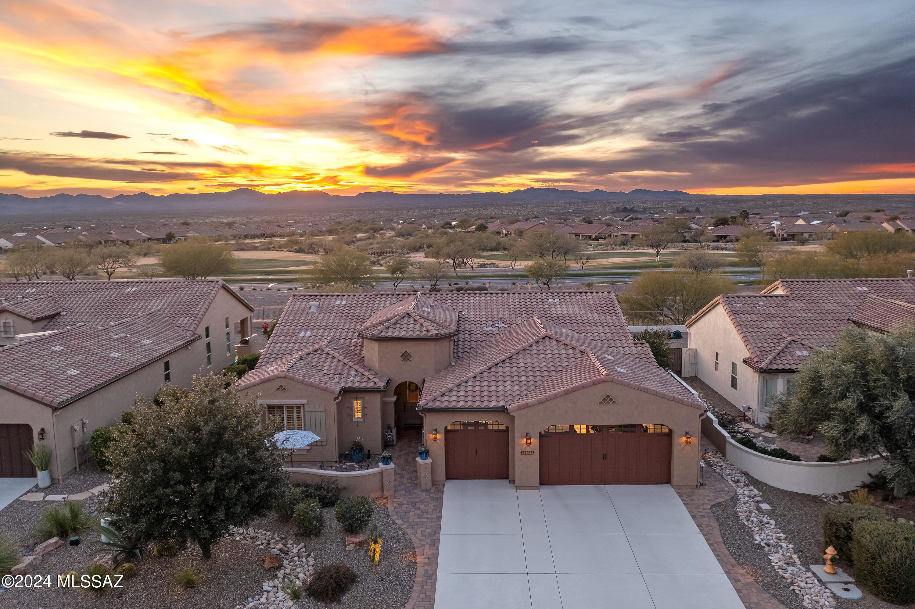 Luxury, elegance and class are the order of the day in this impeccably maintained and thoughtfully upgraded Tesoro model home, overlooking the 10th fairway at Saddlebrooke Ranch. Custom Owned Solar System. Cool, tranquil colors and modern vibes with immaculate attention to detail are all around as you enter this home with an expansive view of desert sunsets. Designer kitchen with a large island, granite counters, custom cabinets, butler pantry with built-in desk and GE Stainless Steel appliances with Advantium oven are a chef's dream. Dining room with custom chandelier that opens to the paver patio with fireplace and rolling shades offer privacy and comfort for entertaining year-round. This home is expanded in the Primary bedroom with views, his and hers walk-in closets and curb less spa like walk-in shower. Spacious Great room has floor to ceiling drapes, gas fireplace and engineered hardwood flooring. The full size 3 car garage offers a 4' extension for extra storage or a workspace with pre-wiring for e vehicle charging station and optional side garage door.  Enjoy freedom from electric utilities with owned solar system saving hundreds of dollars annually. This home has every well-designed upgrade imaginable. Don't wait to live the desert lifestyle.