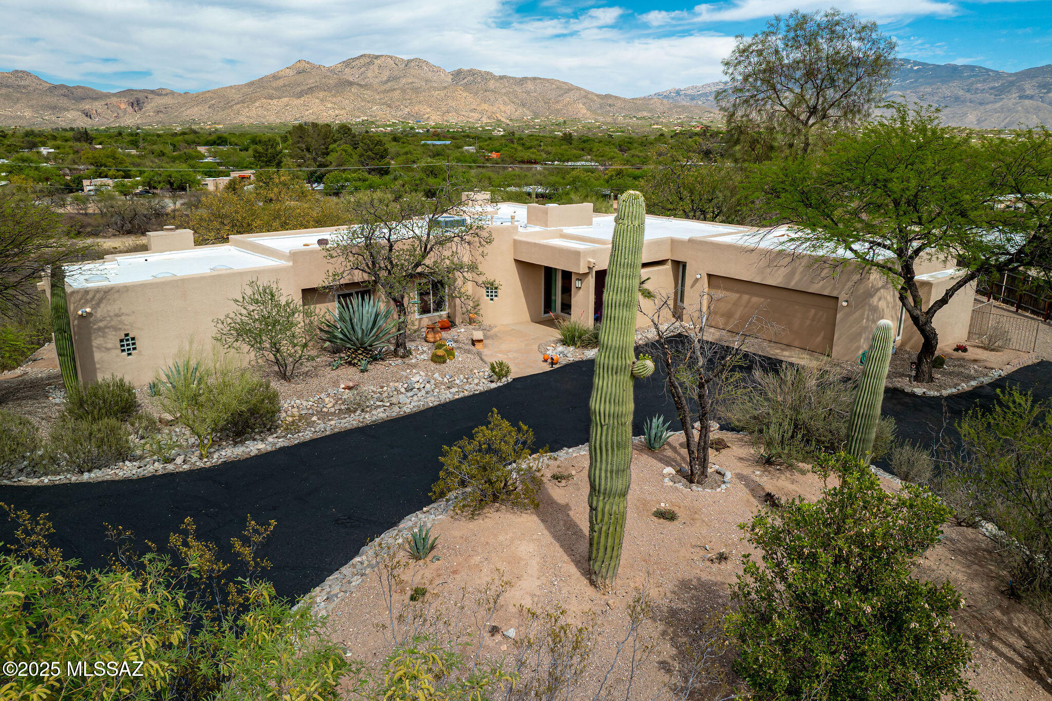 $750k-$825k range pricing. Dreaming of life in the Tanque Verde Valley? Now is your opportunity to experience this incredible 3.4-acre horse property offering breathtaking mountain views and vibrant skies from sunrise to sunset. Whether you're seeking a refined home with privacy or a peaceful retreat for you and your horses, this property delivers.
Designed with a blend of minimalism and functionality, the home emphasizes clean lines, an open floor plan, and a seamless connection to the outdoors. A circular driveway welcomes you to a grand entrance with 8' double doors opening into a spacious foyer that feels like a work of art itself.
At the heart of the home, the kitchen features custom cherry wood cabinetry with pull-out shelving, 42'' upper cabinets, a built-in pantry, under-cabinet lighting, bar seating, a wine refrigerator, a built-in microwave, and a five-burner gas range. From the breakfast nook, enjoy stunning mountain viewsor step outside to a private dining patio for an even closer connection to nature.

Soaring ceilings in the family room frame a cozy gas fireplace nestled between two picture windows showcasing spectacular vistas. The open-concept dining area sits just steps away, offering easy access to the covered patio through sliding glass doorsperfect for indoor-outdoor living.

The private primary suite is tucked away at the end of the home, featuring its own French door to the backyard, a second gas fireplace, and expansive windows bringing the outside in. A custom-designed walk-in closet offers thoughtful organization, while the spa-inspired bathroom boasts dual vanities, an oversized walk-in shower with tile to the ceiling, a rain shower head, abundant natural light, and additional built-in storage.

Just outside the primary suite, the den captures sweeping mountain views and includes a walk-in closet, making it an ideal space for a home office or a potential fourth bedroom.

Bedroom two features dual closets and a cozy window nook perfect for relaxing, plus direct access to a hall bath complete with a jetted tub, quartz countertop, and a skylight.

Bedroom three, located on the south side of the home, offers a private door leading to the backyard and private porch.

The outdoor space is equally inspiring, with thoughtfully designed walking paths that invite you to explore and enjoy the outdoors, while taking in the mountain views. Stone walkway leads down to an expansive covered horse facility complete with three separate storage sheds, alongside a large cleared area making it ready for horse corrals or your future customization. Whether you envision equestrian pursuits or simply wide-open space, this backyard is full of possibilities.

This is a rare opportunity to own an elegant, thoughtfully designed home in a truly breathtaking setting. Schedule your private tour today!