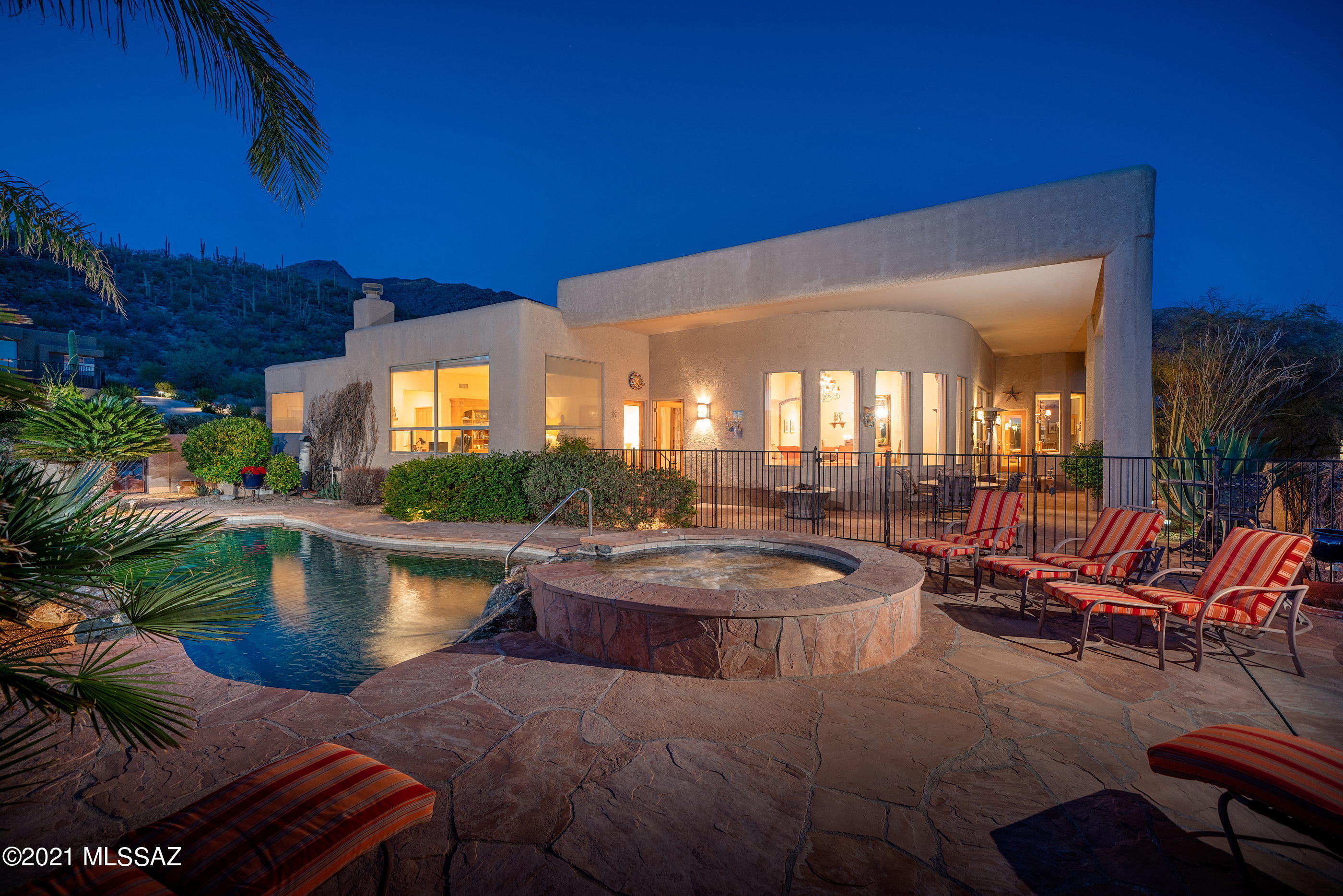 Gorgeous custom home in Alta Vista.  The outdoor living area is so inviting - nook off the kitchen for your morning coffee, bbq area with mountain views, and that pool area!  City lights sparkle!  Inside the split floorplan features tons of windows, a formal living/dining area and large family room off the kitchen.  The master is large with expansive master bath and patio access.  Wonderful foothills home!
