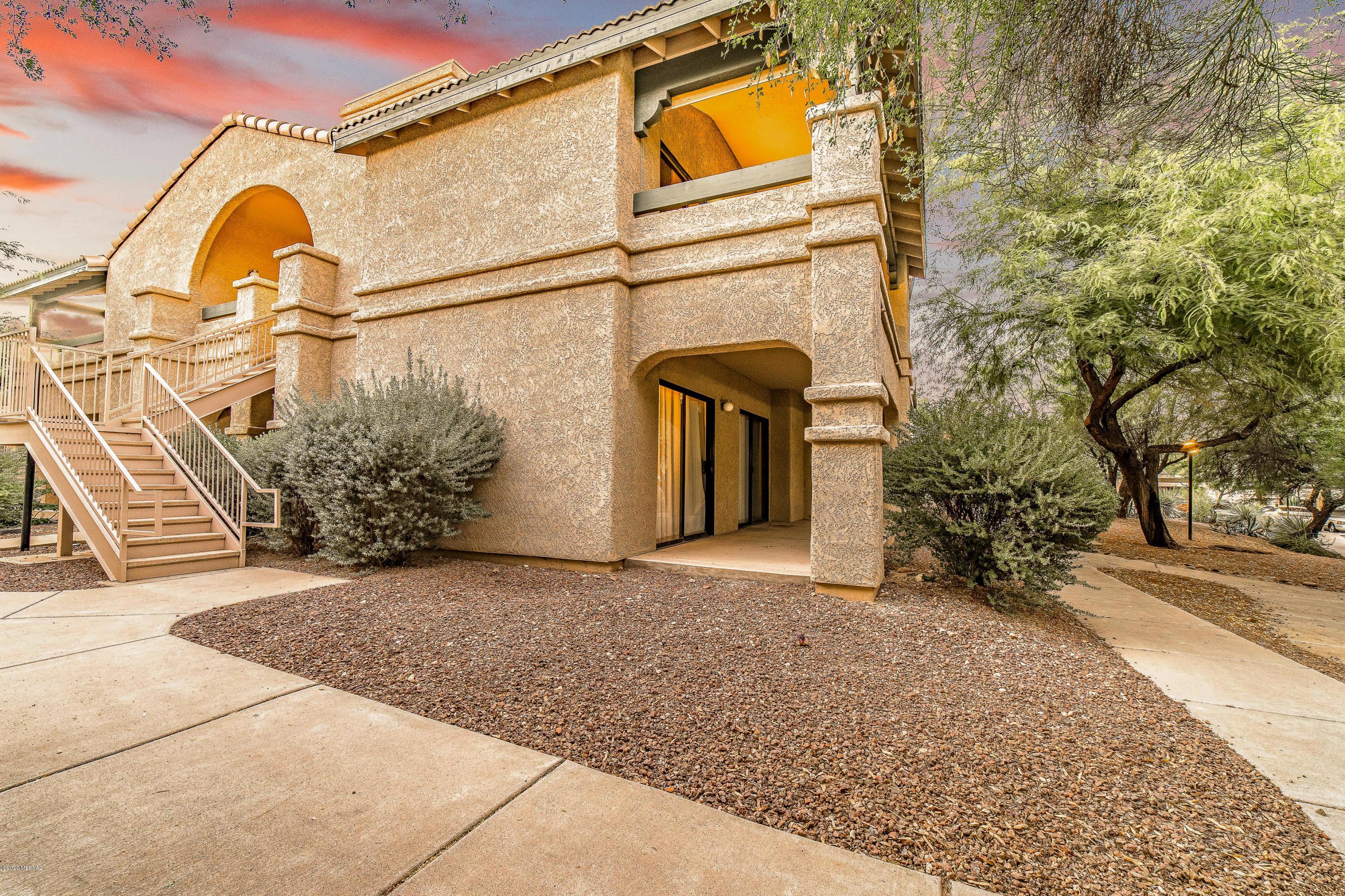 Privacy abound in this Pristine 2nd floor, 3Bed/2Bath condo at highly coveted Moonrise@Starr Pass. From your rockstar covered parking to the peaceful stroll down a shaded walkway to no back neighbors, you are bound to enjoy your new home. Fresh new carpeting throughout & lightly lived-in interior make for a perfect setting. Granite counters, SS appliances & cozy Fireplace. 1st bedroom has double doors and access to porch. Hall laundry & full bath lead to 2nd bedroom & Owner's suite. Spacious closet spaces throughout & storage closet in porch. Relax in your porch surrounded by mature trees &custom roll-down shades.The complex has a pool, weight room, tennis ct. & has an agreement with Starr Pass golf for use of their facilities & discounted golf. HVAC replaced '14, water heater <5yrs old.
