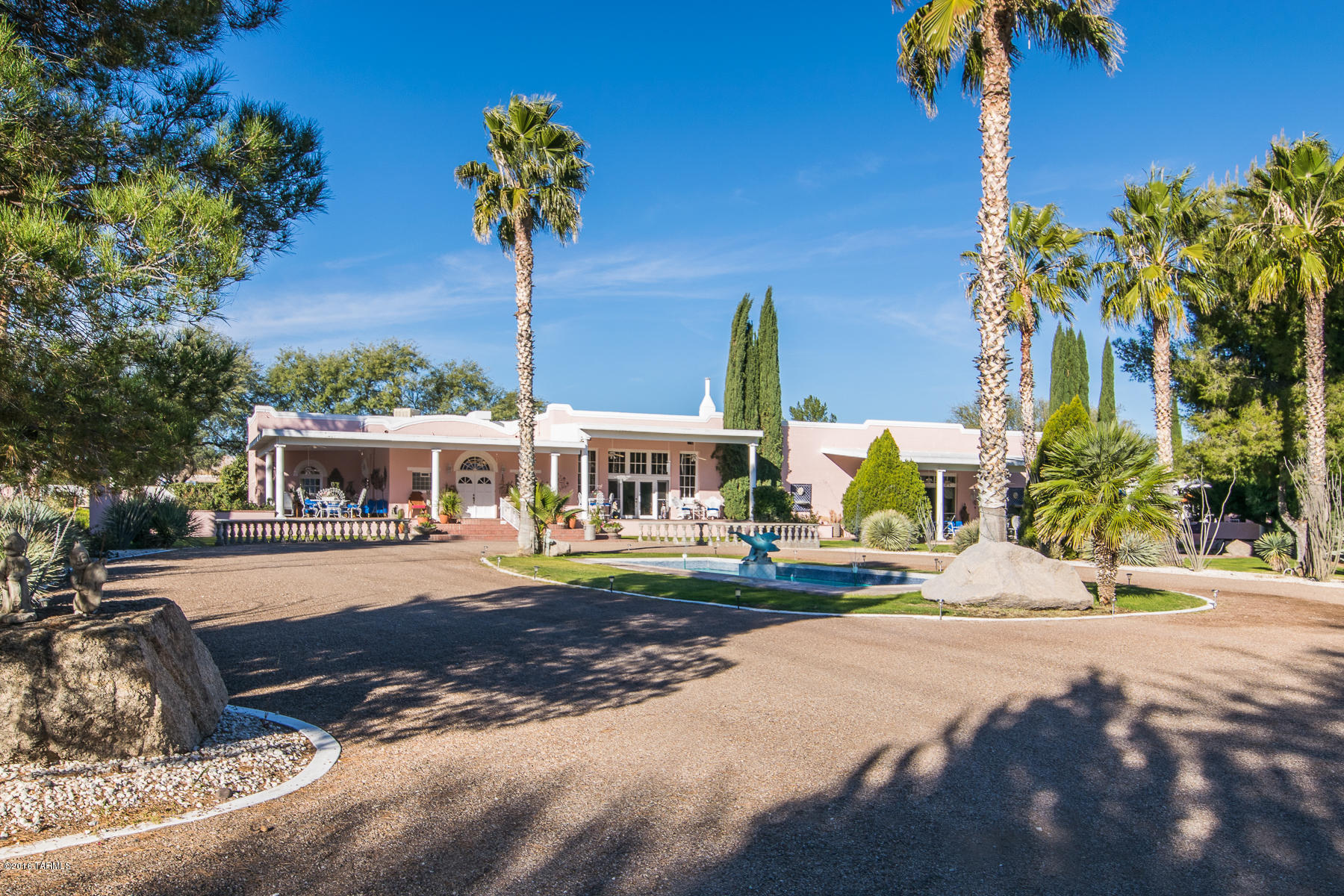 Privacy and elegance are the first words that come to mind when you enter the gates to this historic property. Originally known as the ''Old Amado School House'' dating back to 1925 and designed by Ann Graham Rockfellow who was the first woman graduate of MIT, this property was completely restored by the current owners in 1997. With over 6700 square feet of living space including the old ''teacherage'' or teachers quarters now used as a guest house is perfect for guests, family or a caretaker's quarters. Enjoy walking the grounds through the mature rose garden or enjoy a cool beverage by the pool or take in the stunning sunrises and sunsets from the front patio. There is an adjoining approximately 2.5 acre parcel which could be purchased by a separate transaction. With excellent access to the freeway, proximity to the Green Valley Medical Center and yet approximately 10 minutes to all of the shopping and golf which both Green Valley and the Historic Artisan Village of Tubac, this home is ideally located. The parcel is also zoned for Commercial (B-2) so it may be utilized in ways beyond its current residential use. This property will meet the expectations of your most discriminating buyer.