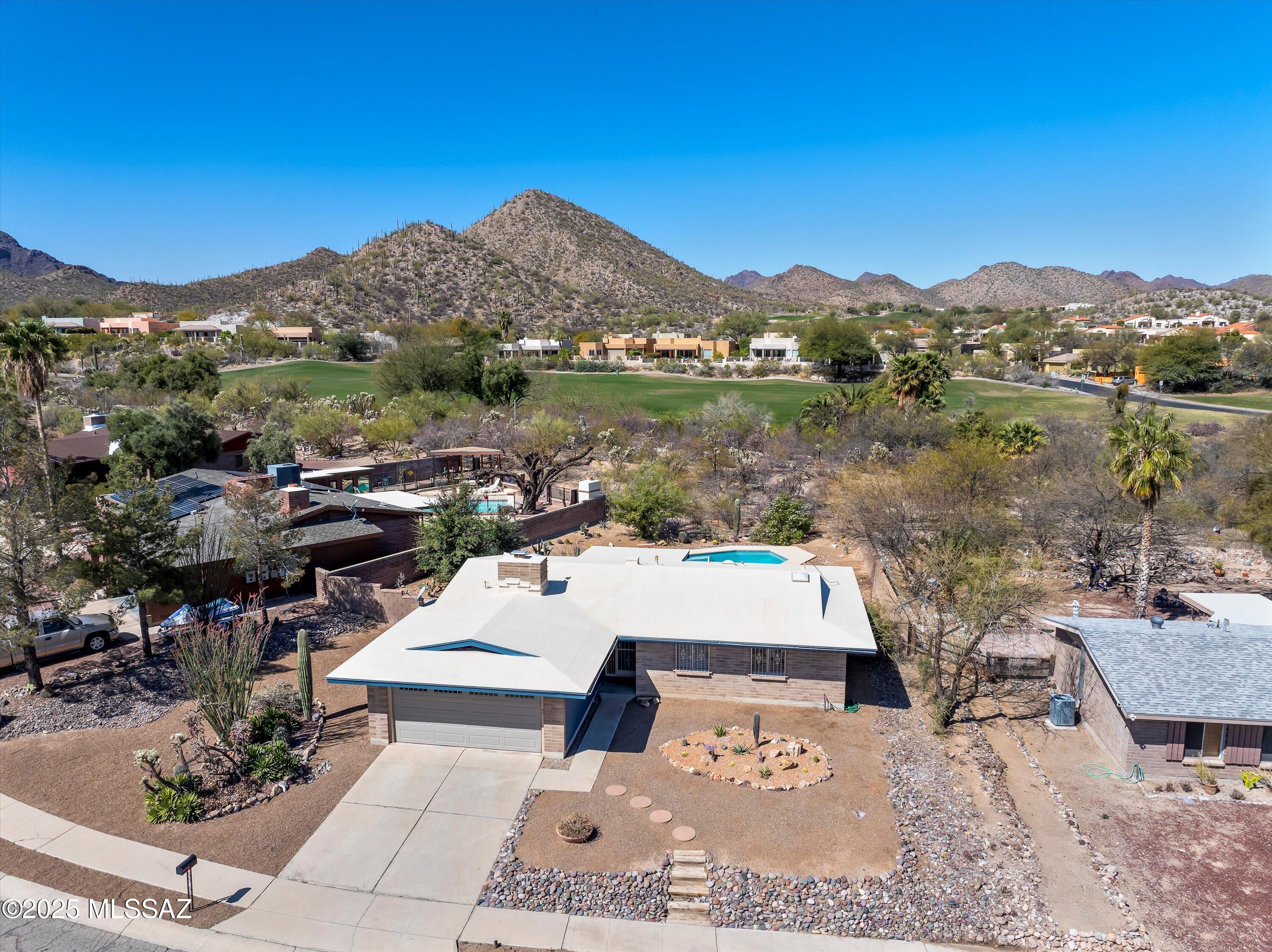 Range pricing: Seller to consider or counter offers between $350K-$375. Elevated lot Single-story home Situated in desirable west side neighborhood! Tucson Mountain Views, Kitchen with granite and SS appliances, 2-car garage, Sparkling pool,  low-maintenance yard.  Inviting atmosphere, cozy fireplace, tile flooring and new carpet in all the right places. Enjoy mountain views from the pool in your nice sized backyard with a covered patio. This desirable location is near the Starr Pass Resort and just through back yard is the golf course; close to golf, hiking trails and downtown offering many dining and shopping opportunities.