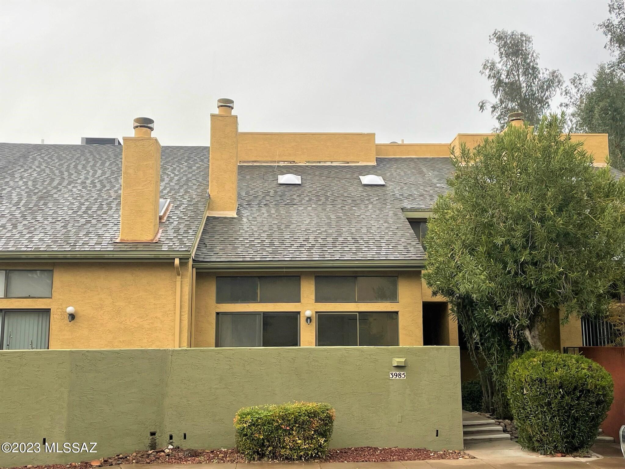 Fix-up. Perfect for investor or remodel for personal residence. Two car garage leads into kitchen and main floor. Large loft that could be TV area, bonus room or even an office area and two very spacious bedrooms & two full baths. Roof work by B & M recoat (2023).  This townhome is in a perfect location steps away from Tucson Racquet Club and the Loop Bike Trail. Near U of A and Banner Campus. Resort style Living with community pool & spa.