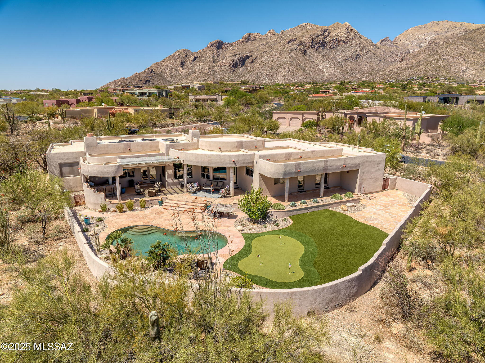 Experience the essence of desert elegance in this warm and inviting Southwest contemporary retreat nestled in the exclusive enclave of Pima Canyon. From the moment you enter, soaring ceilings and an open, light-filled floorplan welcome you with breathtaking mountain and sparkling city views as your backdrop. Designed for both relaxed living and elegant entertaining, the formal dining area flows seamlessly into a cozy living room perfect for gatherings or quiet evenings by the fire. The heart of the home—a beautifully appointed island kitchen—boasts high end finishes and built in beverage fridge perfect for entertaining. Unwind in the generous primary suite, with its luxurious bathroom, and expansive walk-in closet.  Or step outside to a resort-style backyard with pool, bar and BBQ.
