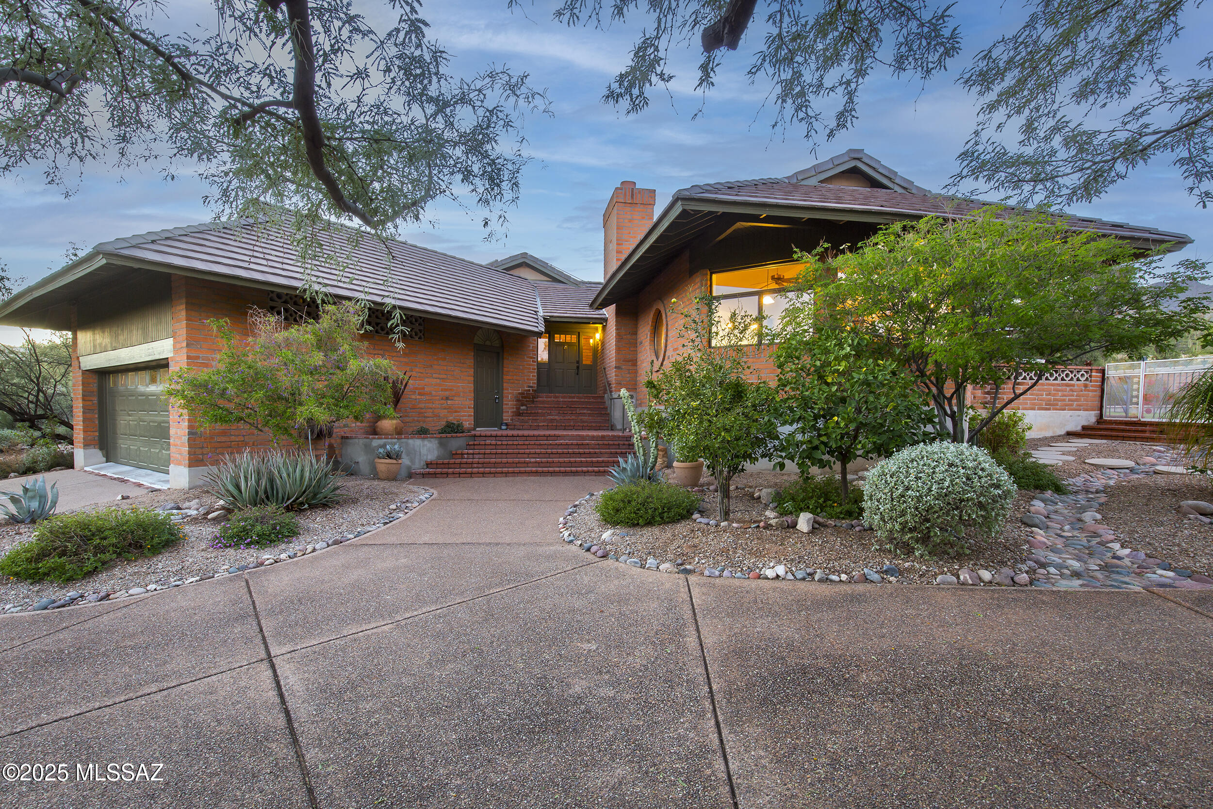 Everyone who enters this charming Foothills home, rounds the corner and steps down into the living room has the same reaction: ''Oh my, what a beautiful view!'' This spectacular three-bedroom, two-bath home sits on just under an acre and offers a rare sense of privacy and serenity. The setting feels secluded with a breathtaking view of Thimble Peak unfolding right from your living room. All of this comes with the convenience of being mere minutes from everything in town. With multiple outdoor spaces, both natural and landscaped, this property offers a complete and effortless lifestyle throughout the private, easy-care yard. The PebbleTec saltwater lap pool is sparkling, with a newly replaced pump and salt cell that ensure everything is in tip-top condition. Additional features include OWNED Solar, a large oversized 2-car garage with a massive amount of storage space, an updated kitchen, hardwood floors in the living room, the bright, open living spaces, and high ceilings that fill the home with an abundance of natural light. This home is clean, freshly painted and truly move-in ready; it is best seen in person to be fully appreciated. Did I mention, there's a lovely view from every room of the house. If school districts are important to you, Via de la Yerba sits in the Catalina Foothills School District.