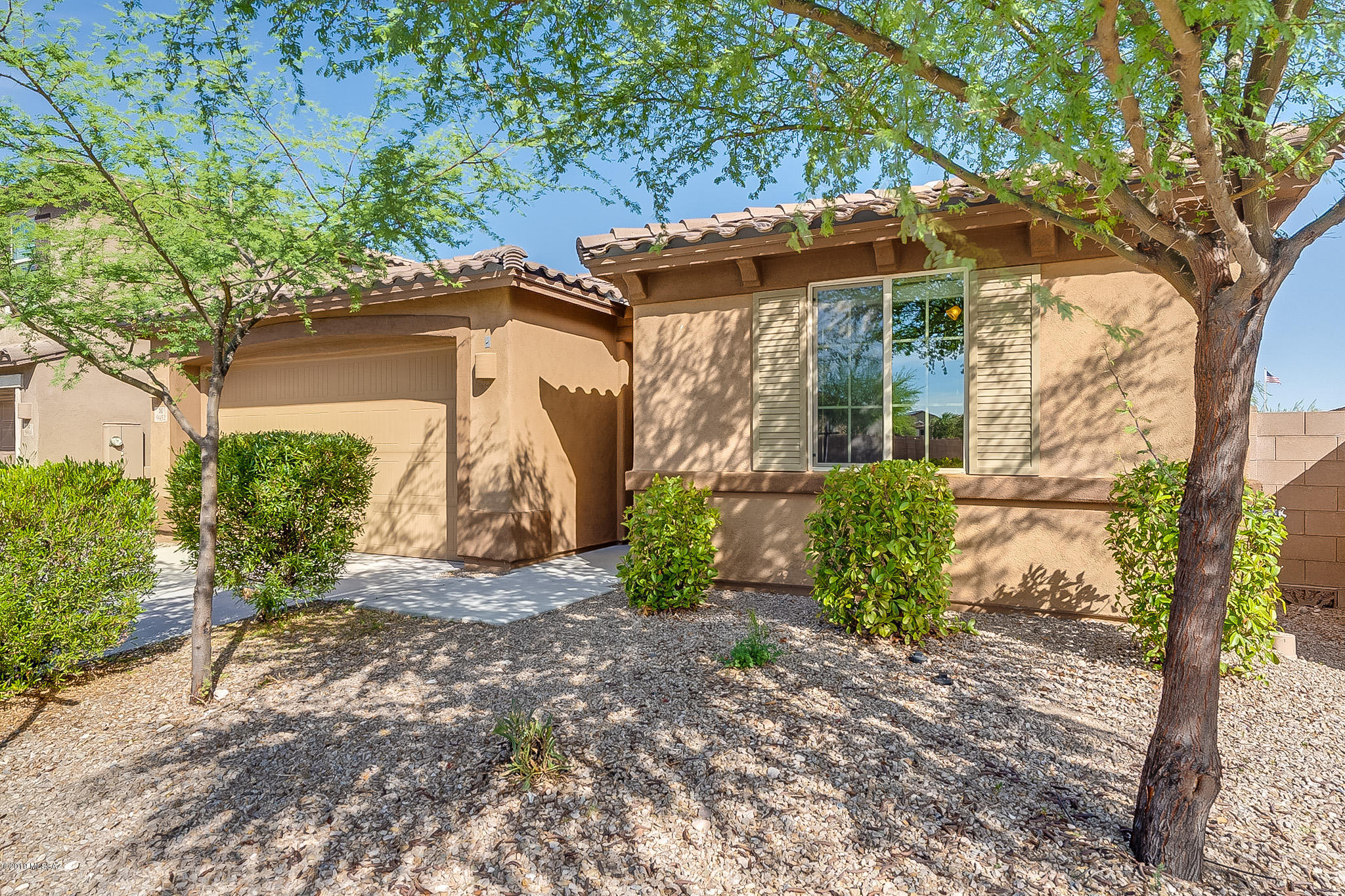 Gorgeous 4bdrm, 3ba, single story w/deep 2-car garage. Richmond American's popular ''Sarah'' model on .14 ac perimeter lot & neighbors on 1 side only in highly regarded Mtn Vail Estates. Enormous, bright great room flrpln w/20'' cstm tile (diagonal) high ceilings & east-facing mtn view wndws. Awesome kitchen w/huge kitchen island-w/pendant lighting & surrounding counter tops all topped w/upgrd granite. SS appliances, w/double ovens, recessed lighting, maple 36'' upper cabinets.  Large bright mstr bdrm; mstr ba w/executive height dual sink counters, sep soaking tub & shower, large walk-in closet. Bdrm 1 has ¾ bath (guest qtrs?). Fans in all rooms. Soft water system & 50-gal water heater. Full finished patio w/recessed lighting. Vail School District & quick access to all essential shopping.