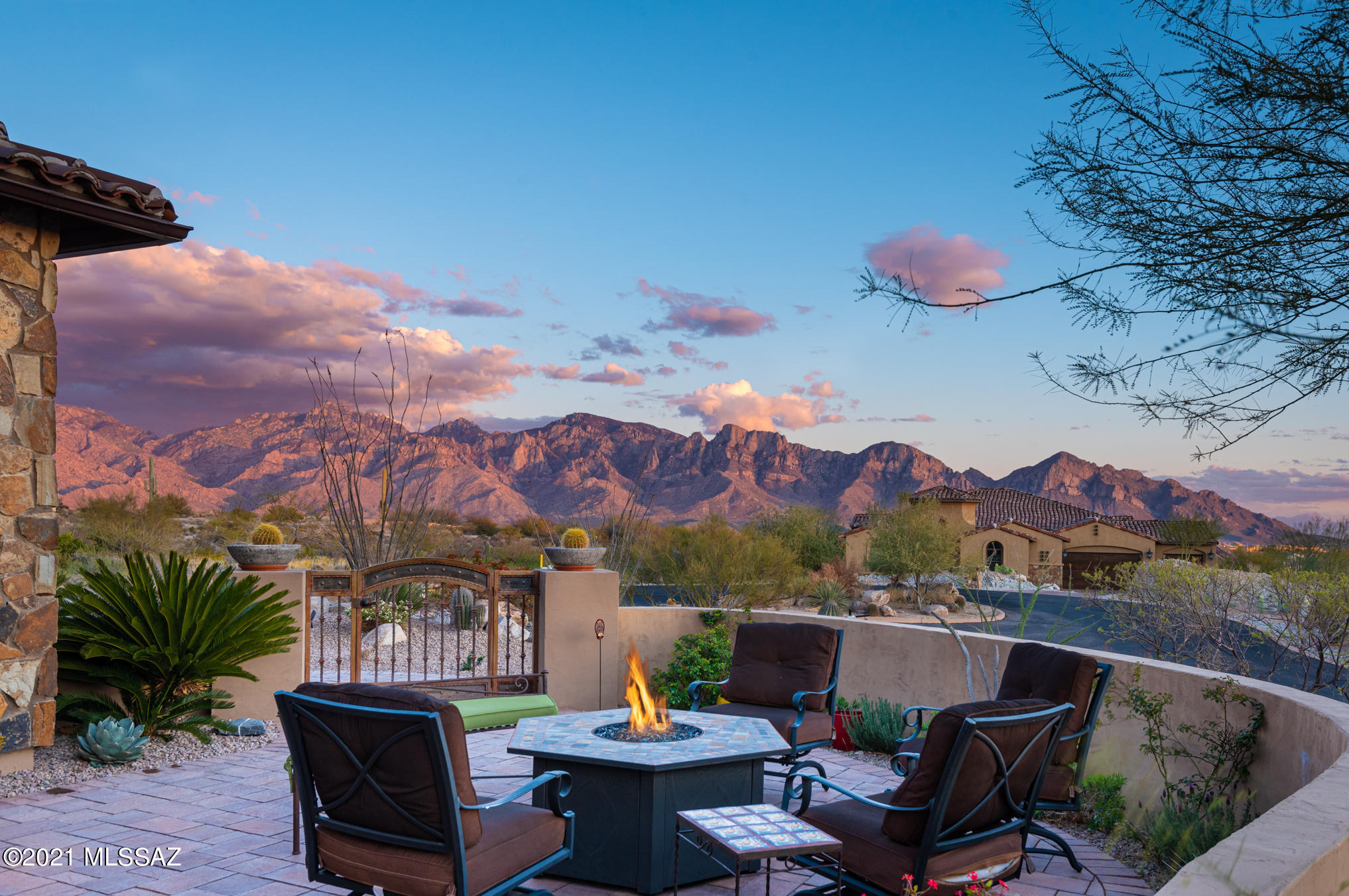 Seller to entertain/counter offers between $1,050,000 - $1,150,000. Guard Gated Stone Gate offers your family an exclusive taste of the Stone Canyon Club, a hallmark of desert golf course living with private events, rec center, pool and clubhouse. A beautiful residence surrounded with Saguaros, boulders, rock outcroppings, mountain and city views. Every inch of this exquisitely designed contemporary home is filled with high-end finishes and attention to details. Spanning over 3,000SF, this split floor plan offers 3 bedrooms with en-suite bathrooms, a pocket den, formal dining room, open great room and a 3 car garage. Luxurious details throughout include travertine, European oak hardwood flooring in dining room, exquisite light fixtures, alder cabinets with crown molding, surround sound, plantation shutters and Hunter Douglas woven wood blinds. You will love the chef's kitchen, stainless steel appliances, wine chiller, massive granite island/bar overlooking the breakfast nook. The great room with fireplace features sliders leading to the covered patio, pool and outdoor kitchen with built-in BBQ, all embracing the picture perfect desert sunsets and mountain views. Request a private tour of the home & Phil Mickelson's Stone Canyon Club.