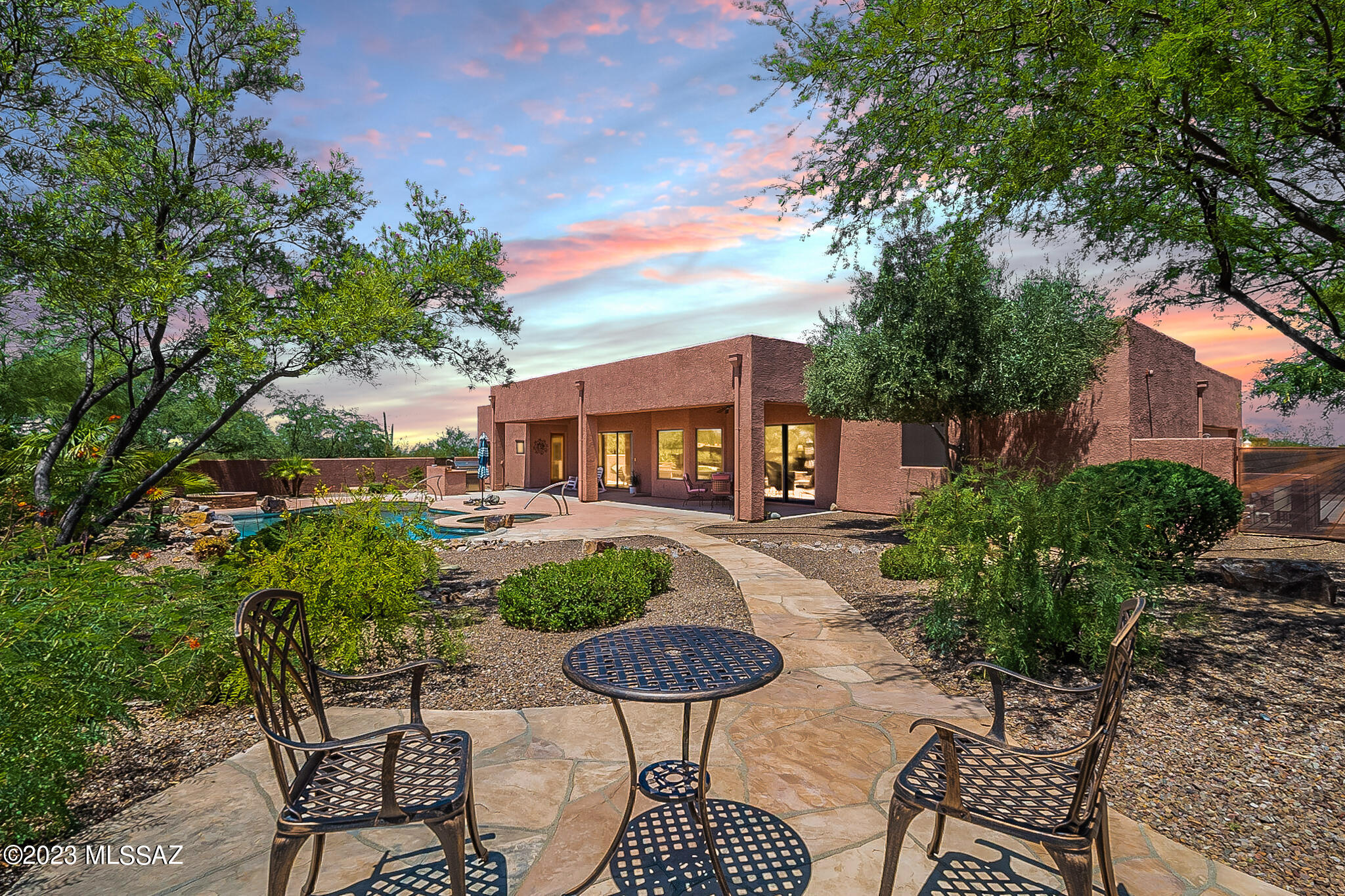 Welcome to your dream desert home! This stunning oasis sits on 1.73 acres of natural beauty, offering tranquility and space. Boasting 3 bedrooms and 3.5 baths, this 3195 sq ft retreat is the epitome of luxury living. The gourmet kitchen features elegant granite countertops, trash compactor, wine frig. and upscale stainless-steel appliances, perfect for culinary enthusiasts. Indulge in the warmth of two fireplaces - one embracing the open design of the primary bedroom, extending gracefully into the primary bathroom, creating an atmosphere of ultimate relaxation. The second fireplace graces the grandeur of the great room, offering cozy comfort and charm.  Indulge in the outdoor oasis, complete with a heated pool and spa, complemented by a mesmerizing water feature. Entertain guests in style with a gas firepit, an outdoor kitchen, making al fresco dining a delightful experience.  Located in a secure gated community, this home is surrounded by nature's splendor and falls within the sought-after Vail School district. As you enter the property, a front courtyard welcomes you with beautiful desert landscaping, adding to the home's allure. This desert gem is everything you've ever imagined and more!