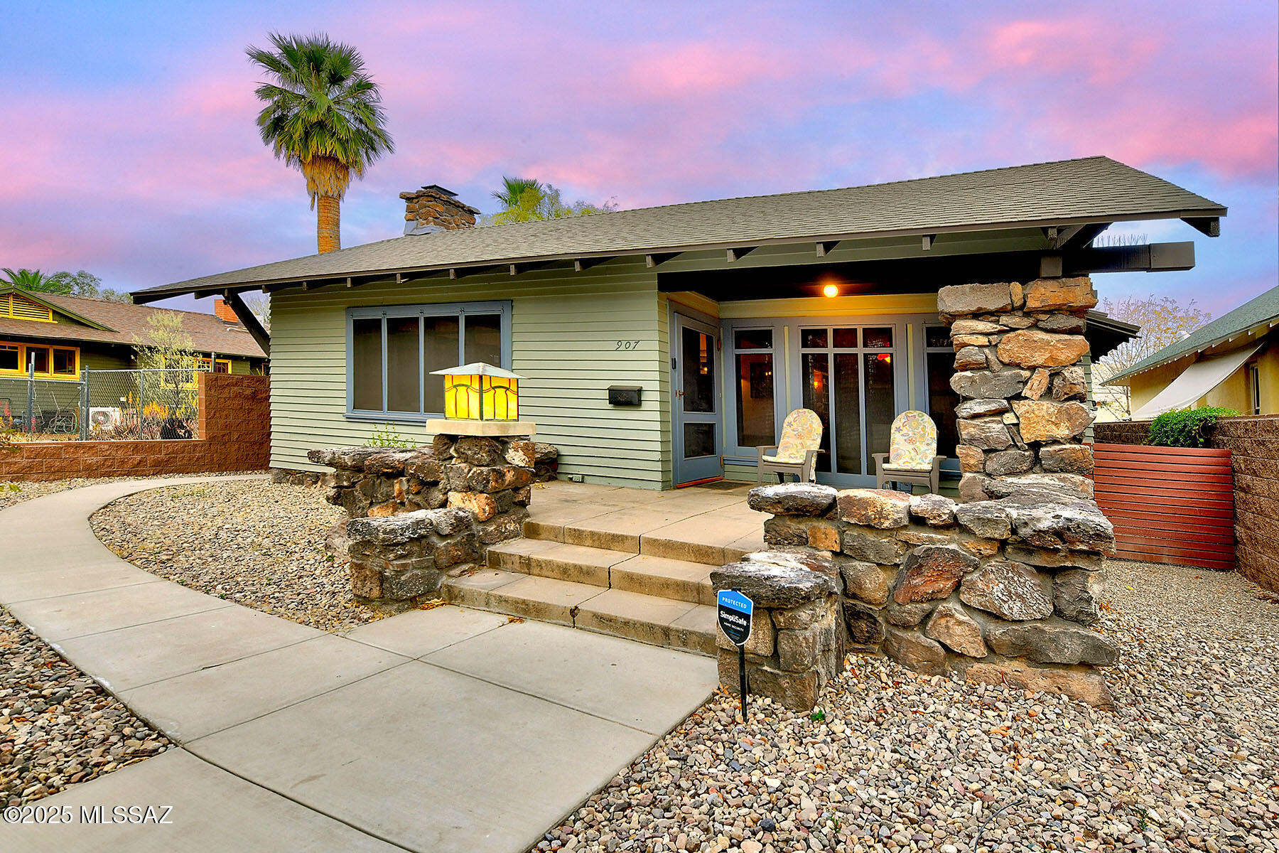 In the heart of West University, the storied ''Rock House'' stands as a rare gem of Tucson's architectural heritage. Lovingly restored, this historic residence is built from volcanic rock quarried from iconic ''A'' Mountain, a testament to enduring craftsmanship. Inside, the original maple wood floors are complemented by finely preserved wood posts and built-in features that echo the home's early 20th-century roots. A striking fireplace anchors the living space, flanked by custom built-ins. The kitchen is a chef's delight—thoughtfully updated with a five-burner range, glass-front cabinetry, mesquite floating shelves, and recessed lighting, all while maintaining the home's classic character. The built-in library adds a touch of sophistication, while the updated hall bath serves the second bedroom. The primary suite offers a peaceful retreat with an ensuite bath featuring a large walk-in shower, a separate soaking tub, and expansive walk-in closets. Comfort is ensured with ceiling-mounted mini splits, and the main house boasts a brand-new roof. A detached guest house completes the property, featuring its own brick fireplace, honed concrete floors, a kitchenette, full bath, and a spacious closet with a built-in dresser, ideal for visitors or extended stays. Fully walled and private, the home sits across from a cherished Catalina park and is recognized on both the City and National Historic Registers. Owner-occupants benefit from a generous 35-45% property tax reduction.  Off street parking in your garage-port. Just a short walk from the University of Arizona, 4th Avenue, downtown, and the Modern Streetcar, the Rock House offers the rare opportunity to own a piece of Tucson history in one of its most vibrant and walkable neighborhoods. The Sellers are licensed Real Estate Brokers in the state of Texas.