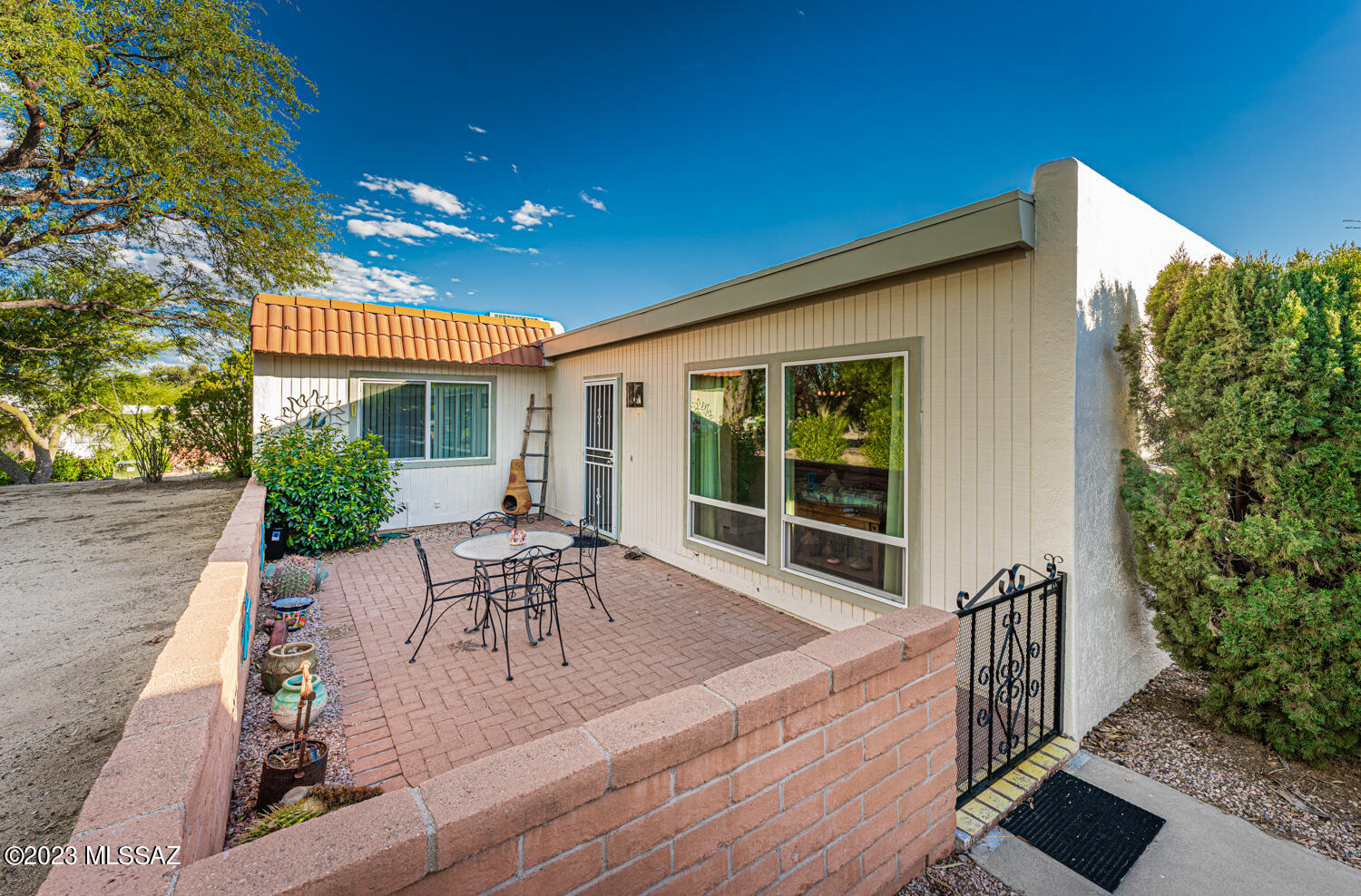 Beautiful end unit townhome in popular Casa Paloma II. Awesome location across from GV Rec pool, spa, shuffleboard & community ctr. 2-car carport. 2 BR/2 BA + bonus room - perfect for office or den.  Updates include newer gas pack HVAC, hot water heater, kitchen counter tops & backsplash, stove, refrigerator, garbage disposal, floor tiles, windows, interior paint, barn door slider to bonus room/office. Lovely front courtyard adjacent to common area, and low maintenance back patio provides a private haven. Enjoy morning sunrises over the Santa Ritas from your back patio. Super convenient to Green Valley Village, shopping & lots of other amenities. Perfect for seasonal or year round. Don't miss this treasure!