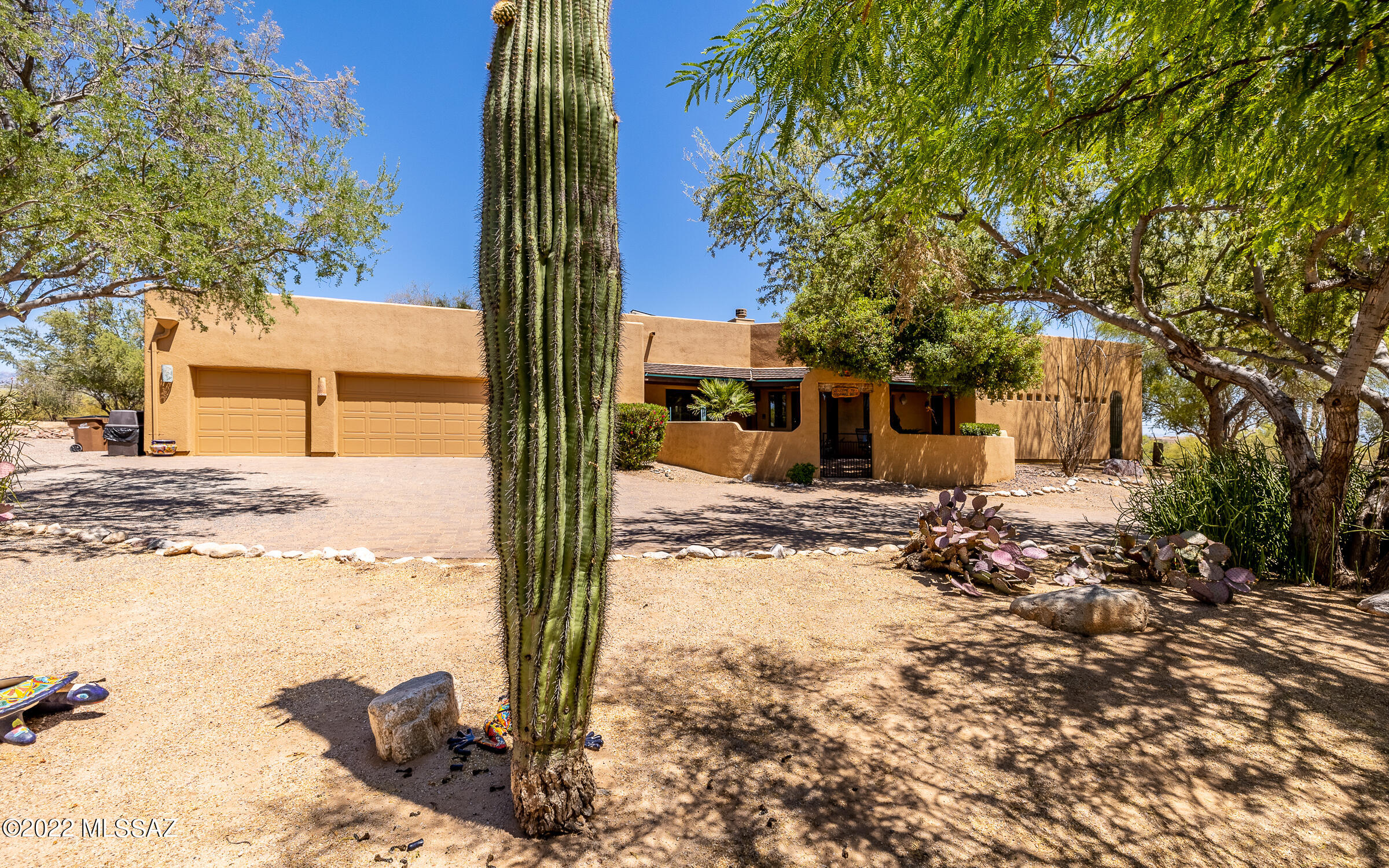 Your Oasis awaits!  Beautiful SW custom home on 3.3 pristine desert acres w/stunning Catalina Mtn views! Gated front courtyard opens to this well defined floor plan. Spacious kitchen offers plenty of cabinets & counter space, huge center island & bar seating with casual dining space & desk work area. Living room w/warm FP, formal dining area & new porcelain tile. No carpet anywhere! Master suite has a cozy retreat, great for relaxing or working out, huge closet & beehive FP. Split plan offers Jack/Jill bath for your guests. Exterior living is an entertainer's delight featuring a pool, new hot tub, covered patio w/fireplace & upstairs deck w/amazing panoramic views! 3 car garage & 3car carport - NEW 1500 sq ft RV garage was just added! Solar & plenty of room for all your toys! This is an amazing home!
