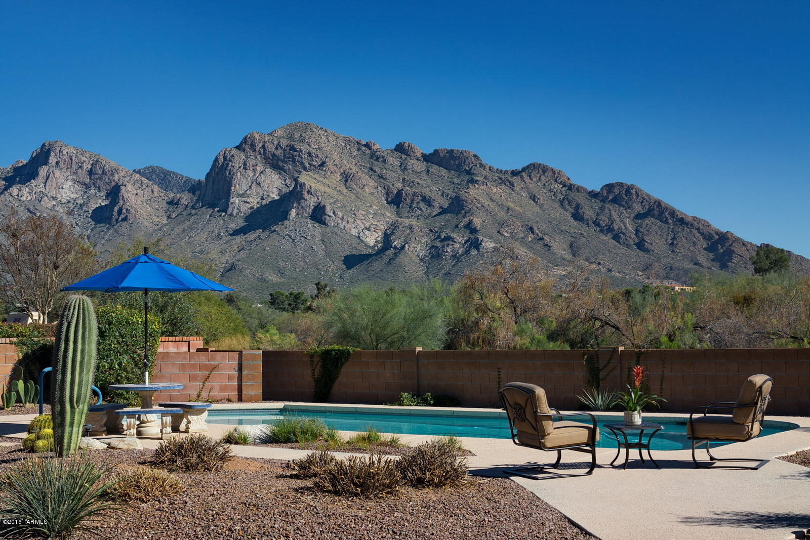 Unobstructed Catalina Mtn views at this very special.36 acre DOUBLE lot property in gated Villages of La Canada! Completely remodeled & freshly painted featuring 17 inch travertine look porcelain tile, upgraded designer lighting, vaulted ceilings & spectacular mountain vistas. Living spaces all open and connected- great flow in this lovely home. Open kitchen has stainless appliances, granite counters & solid alder cabinets. The master suite offers private glass slider to outdoor patio & gorgeous bath with granite counter, walk in shower & soaking tub. 2 guest rooms and chic guest bath round out this charming property.  Show stopping lot with NO ONE behind features different entertaining spaces and sparkling pool. Lots were combined but can be split again with County approval. MUST SEE!