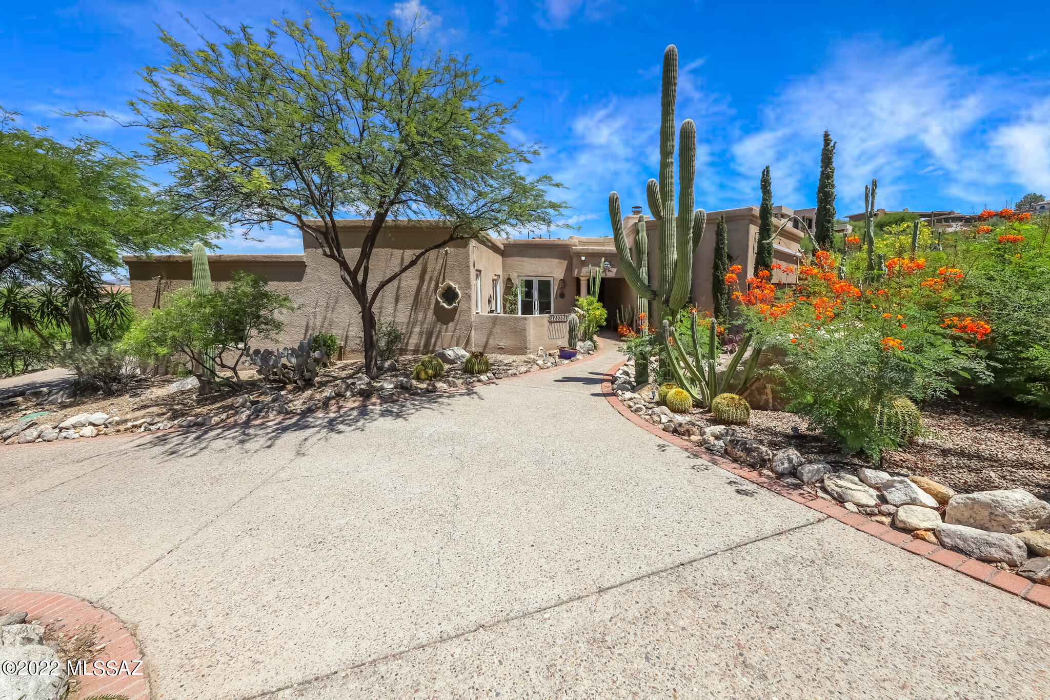 Exceptional Mountain & City Light views! Wonderful 4 Bedroom/3 Bath home in the guard gated community of La Reserve. Features include updated Kitchen with lovely cabinets, newer appliances, quartz counters, large island Bfast Bar & Nook, Formal Dining, Family Room off Kitchen, Living Room with stone fireplace and wall of windows with automatic shades overlooking yard, Pool/Spa and fabulous Pusch Ridge views. Spacious Primary Suite with private courtyard, luxury bath  with jetted tub, sep shower and large closet. Split bedroom floorplan has oversized secondary bedrooms and 2 BR's with jack-n-jill bath. 3 Car Garage with separate heated/cooled Storage Rm. Owned Solar System for low electric bills! Great outdoor living with Pool, Spa, Water Feature, lovely landscaping and incredible views