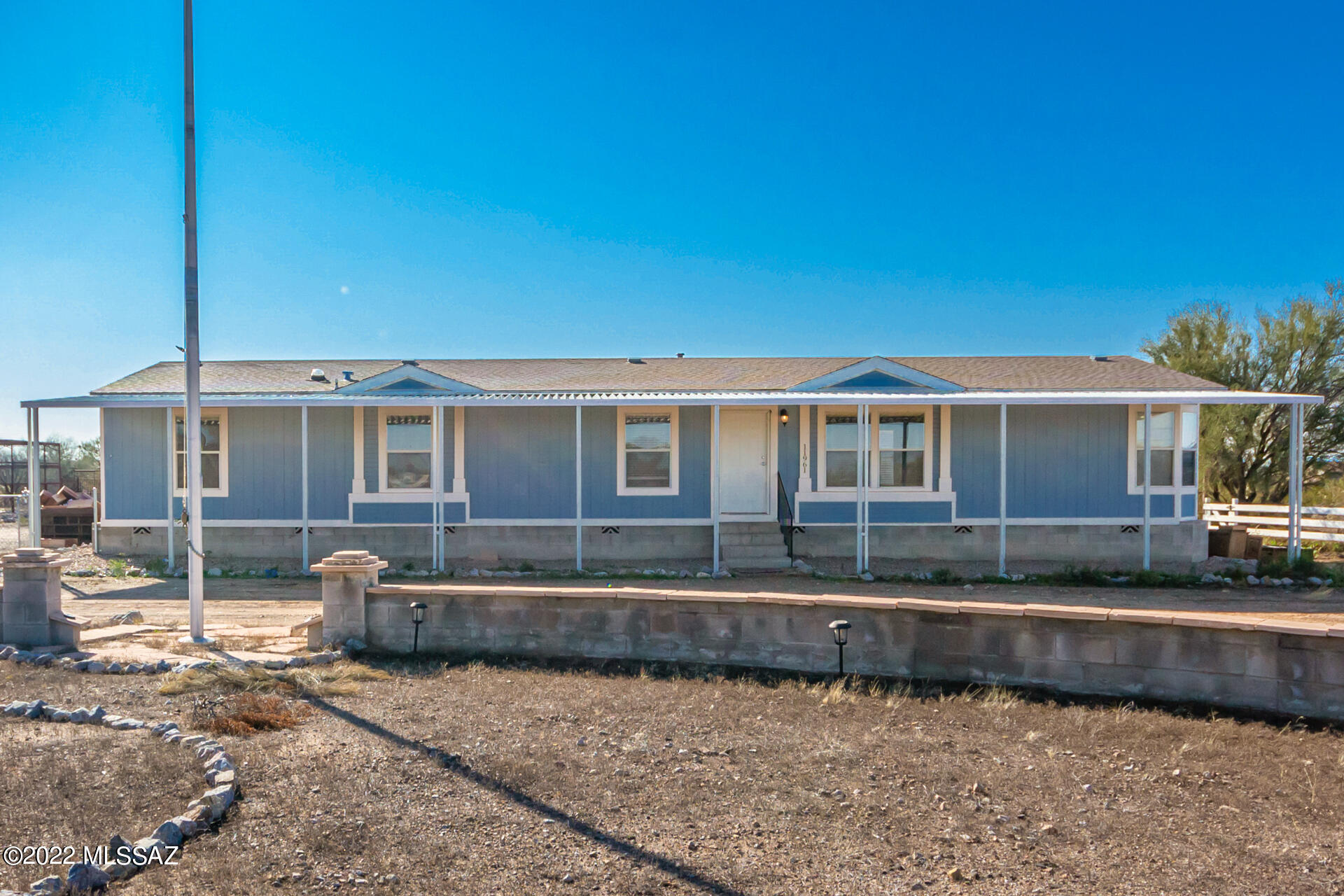 The search is over! This lovely 3-bed, 2-bath mobile home plus den is the one! Displaying a circular driveway & a natural desert landscape. The gorgeous interior features vaulted ceilings, designer paint, wood-look & tile flooring, a welcoming living/dining room, & an open den w/built-in desk ideal for work. You'll love the freestanding fireplace in the family room, which is perfect for keeping you toasty warm! Spotless kitchen is equipped w/recessed lighting, plenty of cabinets, & a center island. Have a good night's sleep in the airy main retreat, including a bay window & a full ensuite w/dual sinks & a walk-in closet. The laundry room has built-in cabinets for extra storage! Spacious backyard offers a full-length covered patio, storage shed, & incredible mountain views. Don't miss it!
