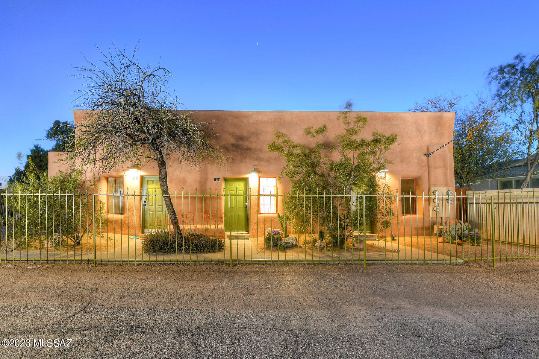 This beautiful, historic Adobe Row house triplex with separate guest home is located in Barrio Santa Rosa, two blocks south of the nationally acclaimed Barrio Viejo in downtown Tucson. This lovingly restored property is a true gem,  and features four charming two-bedroom, one-bath units with enclosed patios that are perfect for pets and entertaining. With 12-foot ceilings and exposed adobe walls, the triplex boasts a unique blend of historic and modern elements that create a truly special atmosphere.
As you enter the units, you'll be greeted by the warm glow of fir wood floors, or vibrant colored concrete floors,  which add to the eclectic charm of the property. Exposed ducting and 10'-12' high wood plank-beamed ceilings further enhance the singular character of the triplex, providing a rustic, yet contemporary feel. The adobe walls are hand-plastered with accent walls in the kitchens providing a pop of color and vibrancy. 
The property has been lovingly restored and cared for, ensuring that it retains its original charm while offering modern amenities for comfortable living. The complex also features a separate 2-bedroom guest home behind the triplex, with tiled floors that provides additional space for the homeowner, guests or potential rental income. The oversized parking lot on the property offers ample off-street parking, almost unheard of in Barrio Viejo or Barrio Santa Rosa. 
The location of the triplex is unbeatable, with its proximity to 5 Points, Downtown, the Modern Streetcar, and other local attractions. This makes it an ideal property for potential use as an Airbnb, providing a unique and convenient accommodation option for visitors to the area.
In summary, this Row House with a guest home in Santa Rosa Barrio is a one-of-a-kind property with three a beautifully restored adobe triplex  units and a separate guest home, all brimming with character and charm. With its unique features, prime location, and potential for use as an Airbnb, it presents an incredible opportunity for those seeking a special property in the heart of historic Santa Rosa.