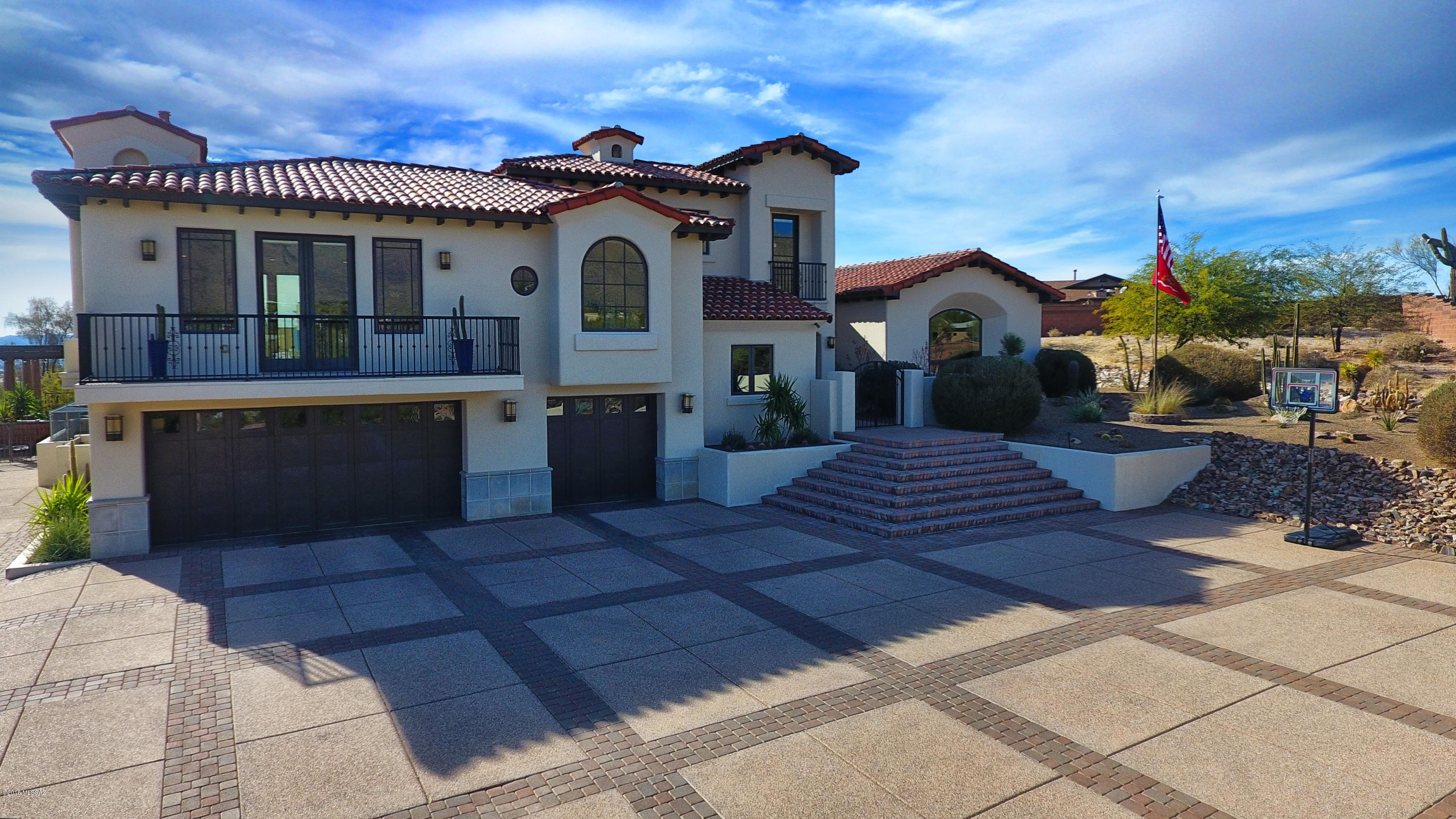 Absolutely stunning custom home in the exclusive Catalina Foothills neighborhood without the hassles of a HOA.  Spacious flowing 4 bedroom with 6 baths give plenty of room for family and entertaining.  Formal living dining with high ceilings and spectacular mountain views.  Hardwood floors and natural stone throughout.  Fireplaces in 4 separate areas including the lavish backyard.  Relaxing master suite with awesome custom bath, walk in closet and private deck with twinkling night city views.  Resort style living outside with every square foot meticulously designed to enjoy all year long!  Truly too many upgrades to list here and a MUST see in person to appreciate!  See attached upgrade list.