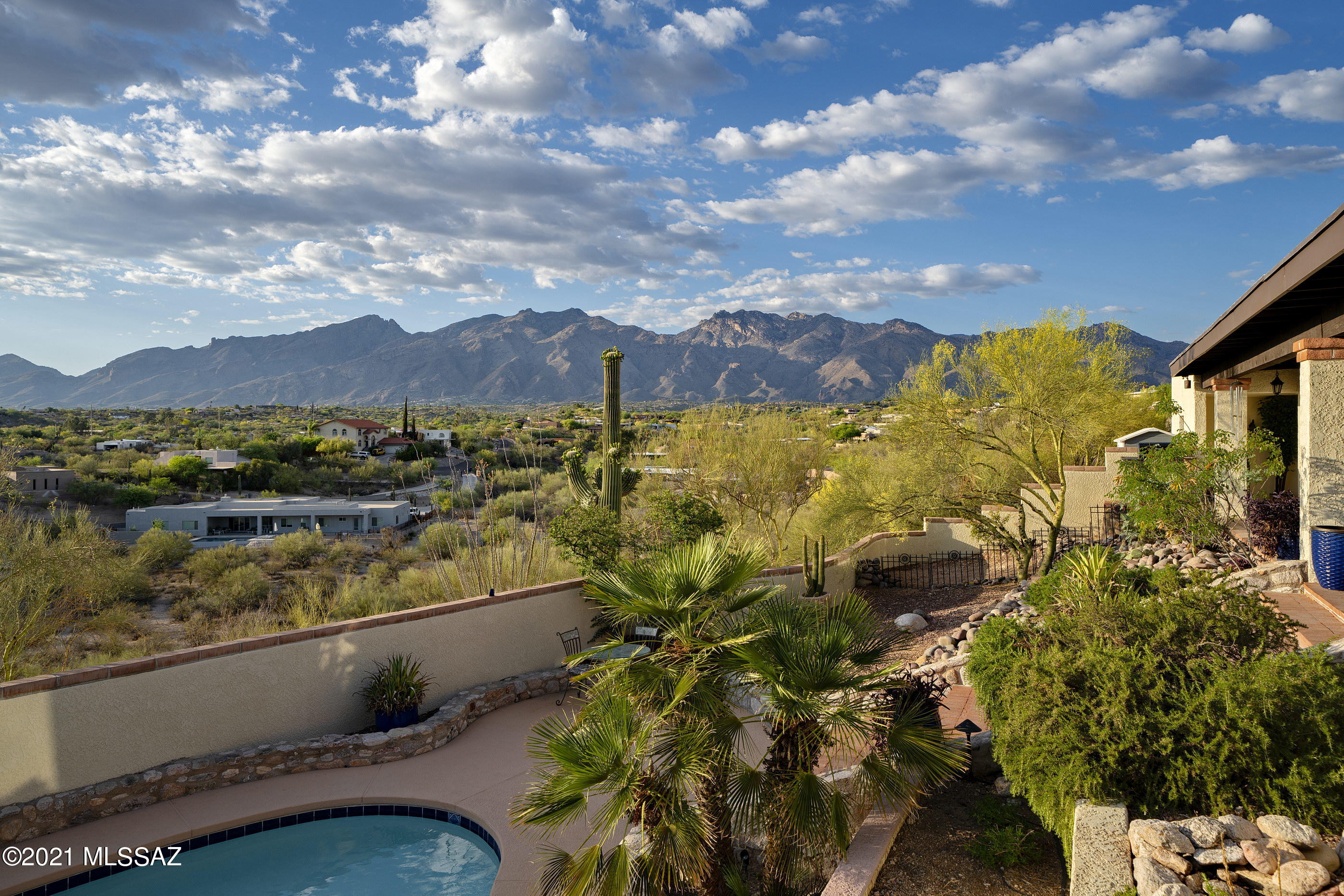 Prepare to be wowed by this beautiful home loaded with architectural interest! 2924 square foot, 3 bedroom + den, 3 bath home is situated on a hilltop lot with stunning mountain & city light views. Main living space has soaring wood ceilings. Hardwood & ceramic tile throughout the home—no carpet. All living & dining spaces overlook & have access to the gorgeous rear outdoor space with pool. Kitchen has been remodeled & features a full stainless appliance package, granite counters & pantry closet. Family room off kitchen has mountain views & a natural Cantera stone fireplace. Main bedroom features another Cantera fireplace, more views, 2 closets (1 walk-in + 1 California Closet) & en suite bath. 2 guest bedrooms are serviced by a full guest bath. See attached doc for more details.