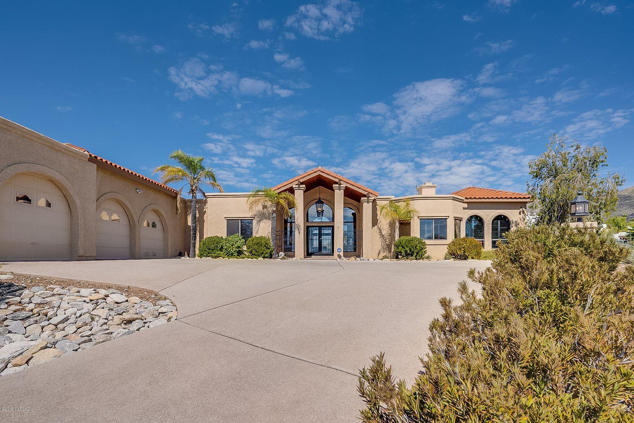 Enjoy the Tucson Lifestyle in this incredible custom Gary Almli built home w/360º views. The cook's kitchen offers SS appliances, sub-zero refrigerator, gas range, double wine refrigerator, concrete counters, pantry. The intimate formal dining room has impressive views! Large picture windows, elegant brick shaped pavers, highlights a free standing porcelain tub, 3 car garage has own evap cooler/great storage & workshop areas! Mature Landscaping graces the backyard. Soak up all the views in the sparkling pool.Easy walk to La Encantada. No need to preview! This is the one!