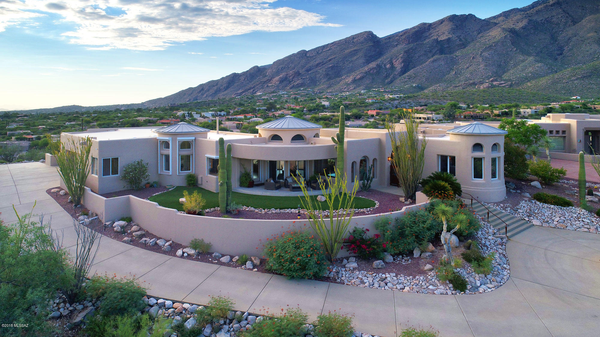 JAW DROPPING VIEWS... The ultimate Stunning Ridge Top Soft Contemporary designed by renown Southern Arizona architect, Ron Robinette and Interiors by Lori Carroll & Associates, ASID, is now available.  Home sited on cul-de-sac lot in exclusive Alta Vista Est. Infuses deep rich organic woods throughout, custom metal finishes by artisan/craftsman detail cabinets & FP. Kitchen boasts amazing city views & copper faced cabinets, which opens to a comfortable Family Room. Be inspired working behind architecturally contemporary designed desk from home office w/EXPLOSIVE MOUNTAIN VIEWS!! Retreat to your master suite with FP & sitting area overlooking majestic city and mountain views! Powder Room highlights radius maple & metal faced cabinet cradling glass vanity & sink. The ultimate luxury home!