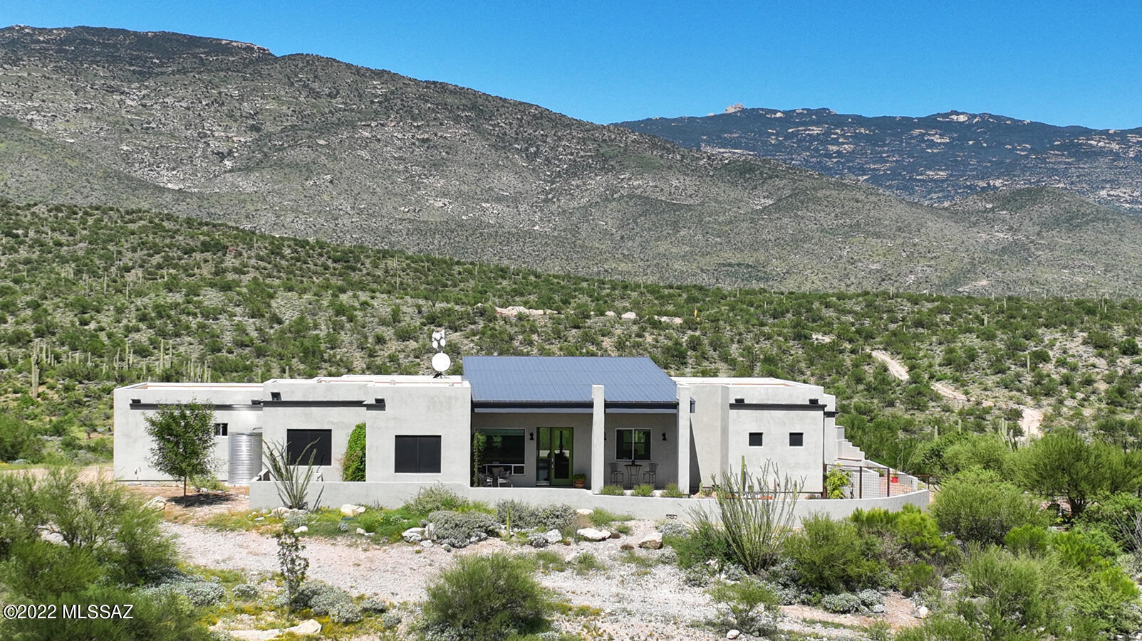 Absolutely breathtaking mountain, sunset & desert views are enjoyed from this stunning custom hm perched high atop a magnificent 20-AC dividable parcel boasting peace & tranquility most people only dream of.  Inside, the sky hi ceilings, 
gorgeous concrete flrs, fabulous wall of windows soaking in the views & beautifully crafted open kitchen w/lg island, lovely tile backsplash, SS appl & walk-in pantry will make you realize you are home. Primary Ste has long dbl vanity, lg tub & striking stone shower and again...more views! Meticulously developed bkyd showcasing blt-in BBQ, firepit, brick pavers, fabulous FP & unparalleled vistas in all directions.  Brand new Honeywell generator, Blt-in sound system, RO H20 Softener.  Free hi speed internet option can be incl. Private well w/2500-Gal tank