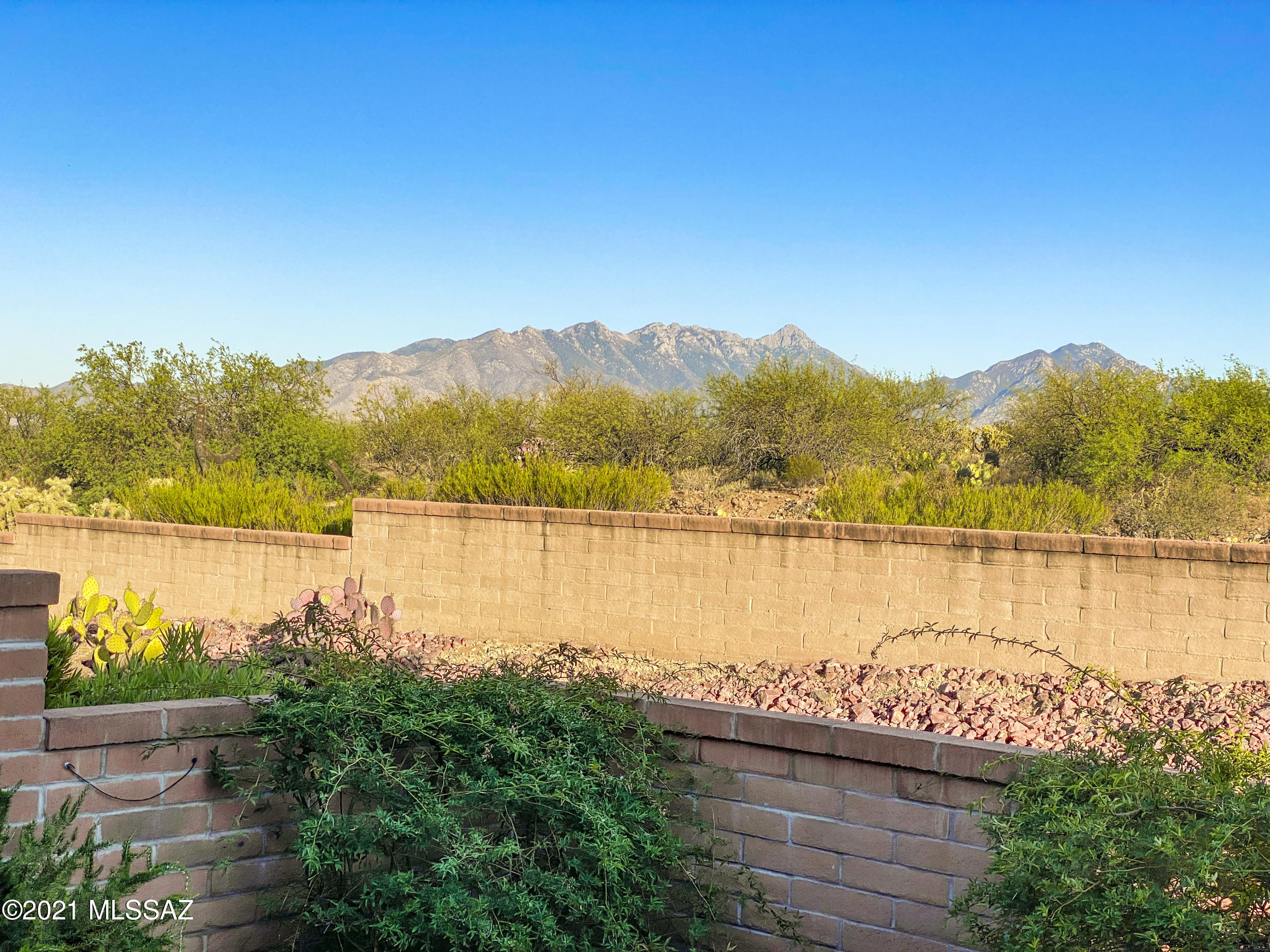 Here you go!  A well-maintained townhouse with a mountain view under $200,000!  The efficient layout with 2 bedrooms and 2 baths will be the perfect place for your winter getaway.  Step inside and you will notice the beautiful Saltillo flooring that sets the tone for living in the southwest.  You'll also notice the skylight and the window over the kitchen sink bringing in natural light to the kitchen.  The living area has plenty of space for everyone to relax with friends or watch your favorite movies.  The back patio is the perfect place to unwind at the end of the day as you watch the changing colors in the sky above the Santa Rita Mountains.  And if you are looking for easy exercise and walking trails, this home is conveniently located near Desert Hills Recreation Center and Canoa Trail Park which makes this gem an ideal location too!